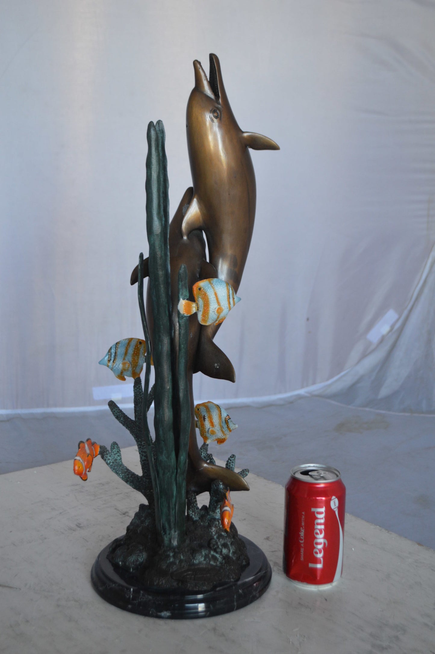 Two dolphins with fish, table top bronze statue. - Size: 8"L x 8"W x 22"H.