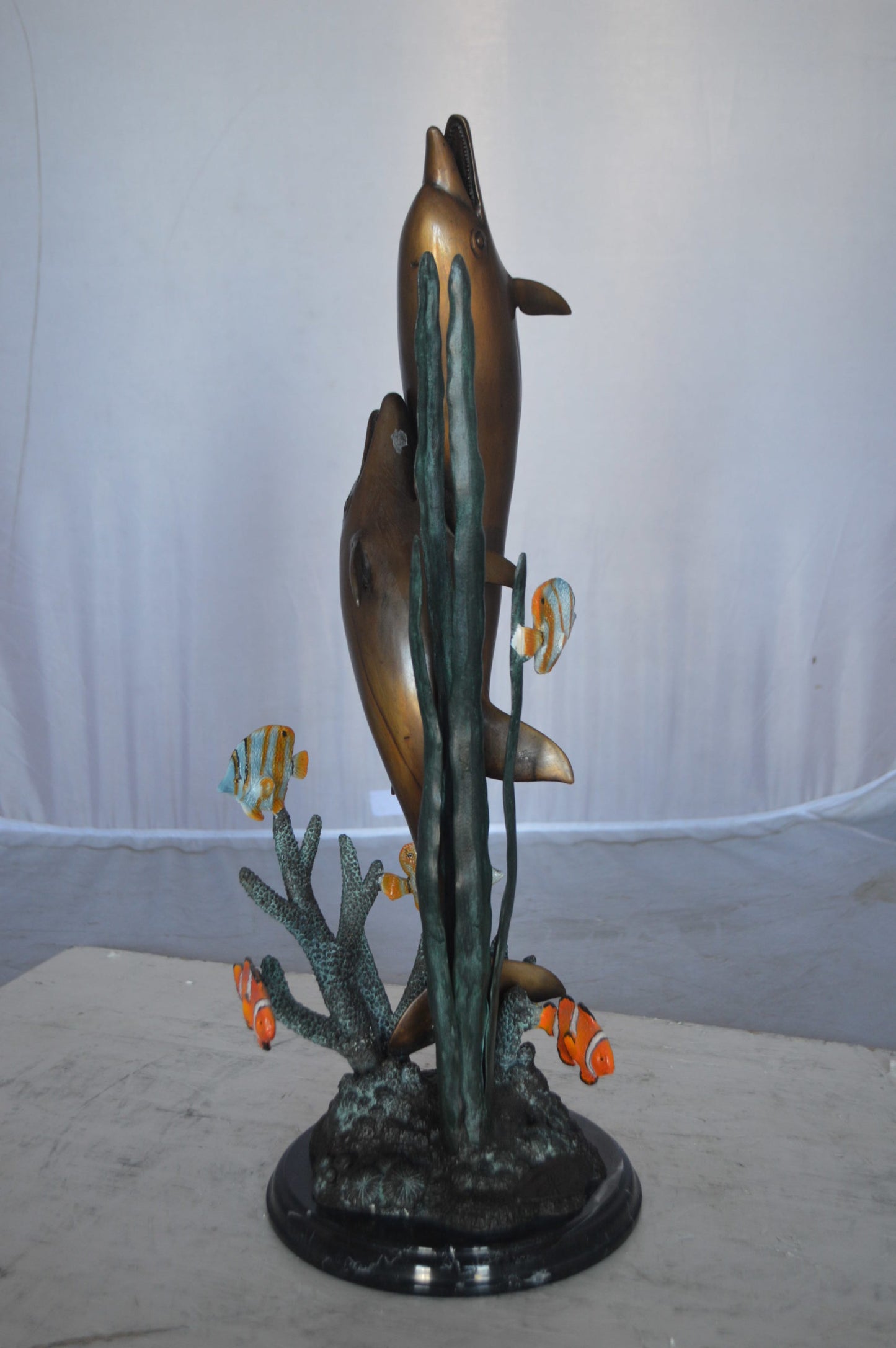 Two dolphins with fish, table top bronze statue. - Size: 8"L x 8"W x 22"H.