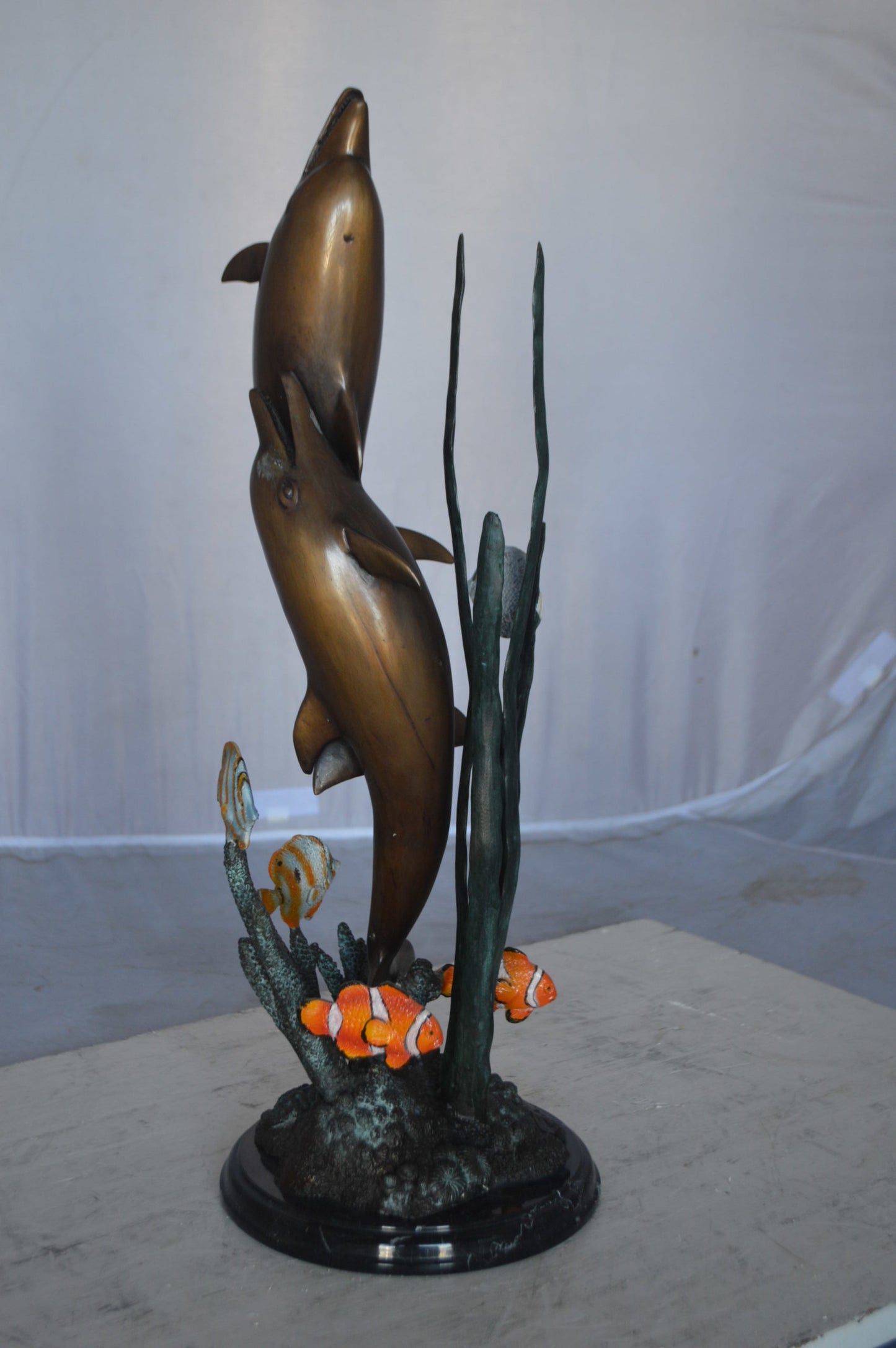 Two dolphins with fish, table top bronze statue. - Size: 8"L x 8"W x 22"H.