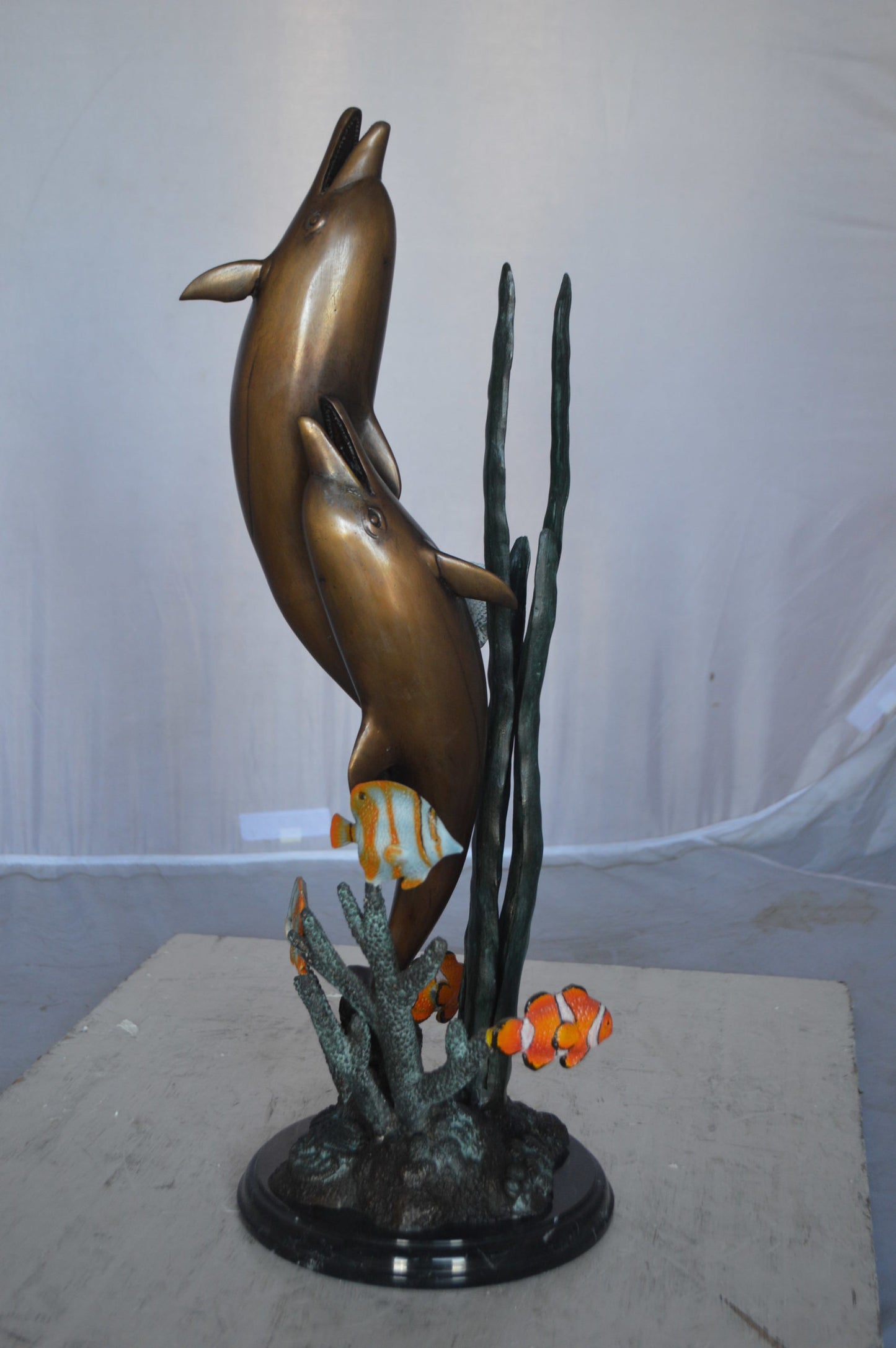 Two dolphins with fish, table top bronze statue. - Size: 8"L x 8"W x 22"H.