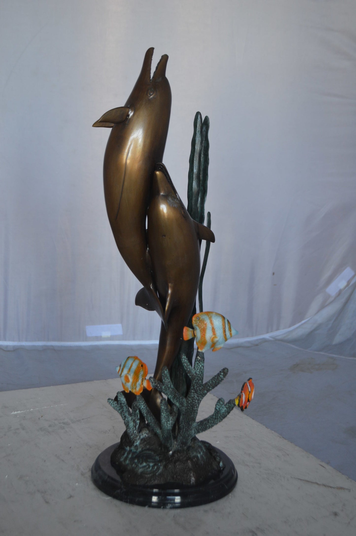 Two dolphins with fish, table top bronze statue. - Size: 8"L x 8"W x 22"H.