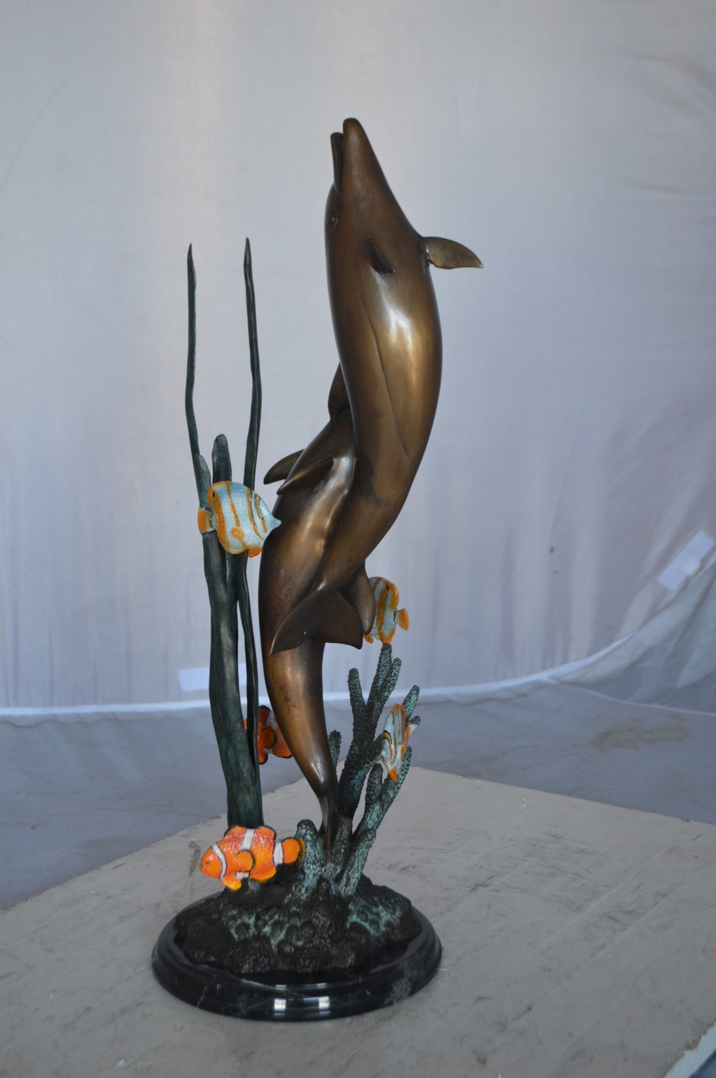 Two dolphins with fish, table top bronze statue. - Size: 8"L x 8"W x 22"H.