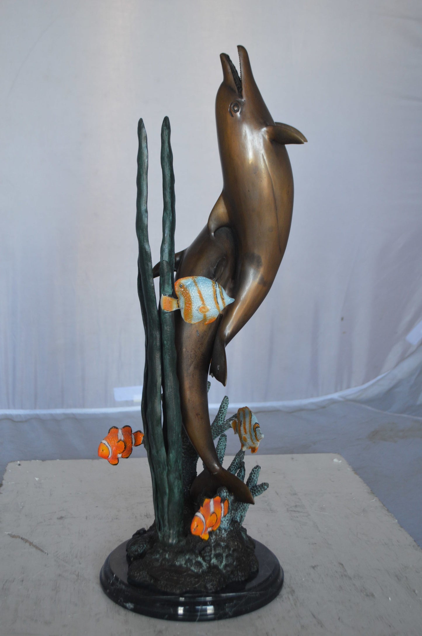 Two dolphins with fish, table top bronze statue. - Size: 8"L x 8"W x 22"H.