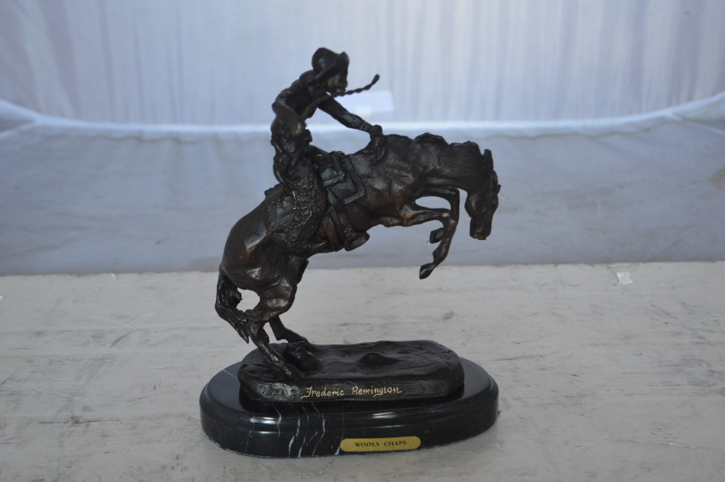 Wooly Chaps Bronze Statue by Remington 13H - Size: 8"L x 3"W x 9"H.