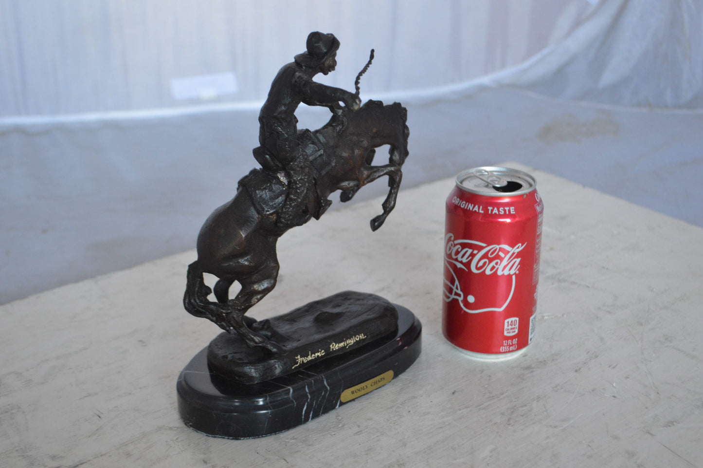 Wooly Chaps Bronze Statue by Remington 13H -  Size: 8"L x 3"W x 9"H.