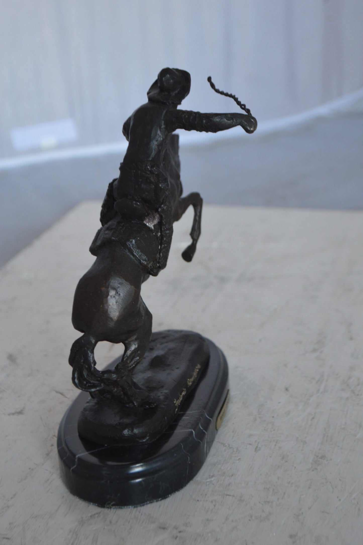 Wooly Chaps Bronze Statue by Remington 13H -  Size: 8"L x 3"W x 9"H.