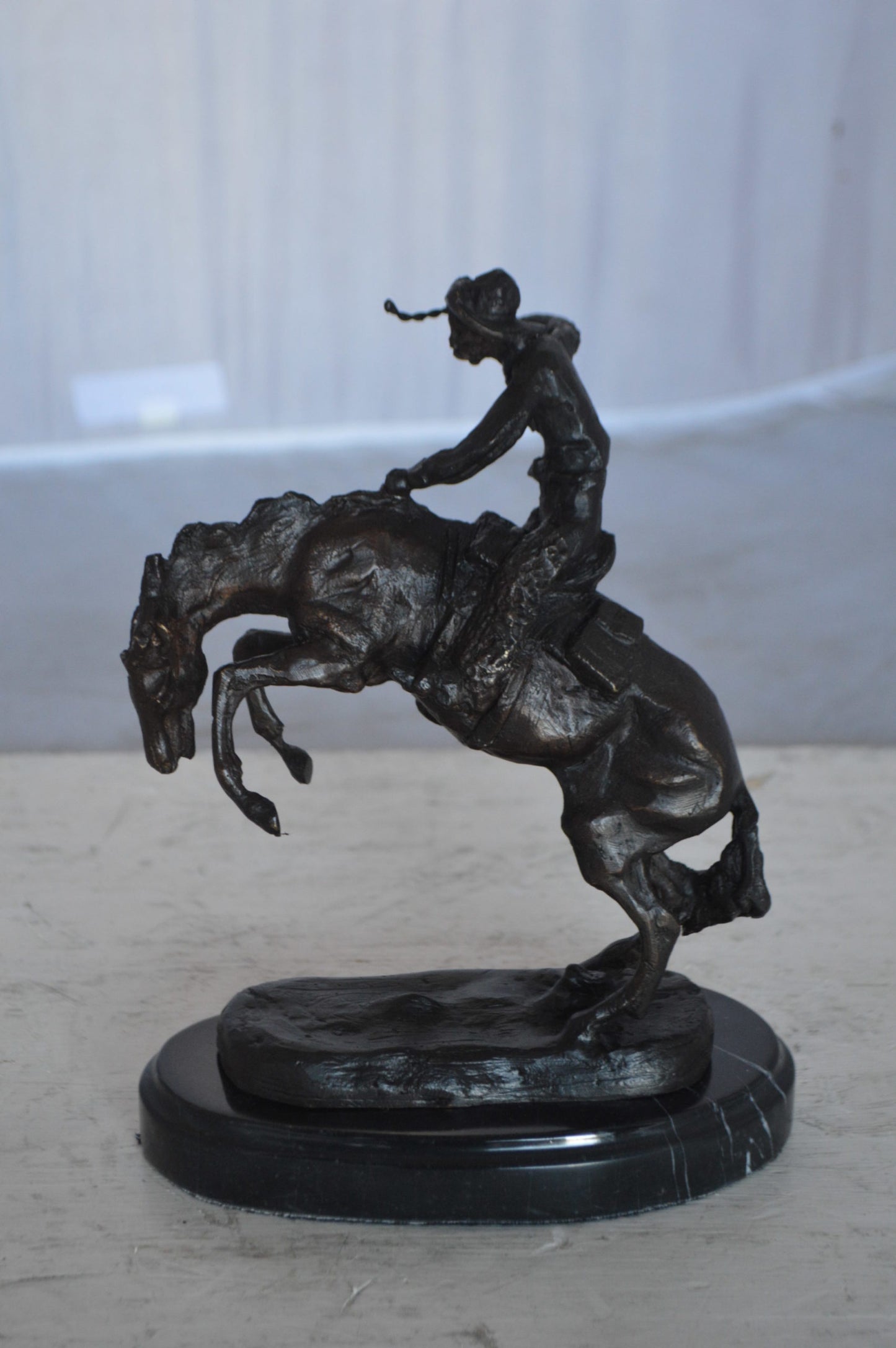 Wooly Chaps Bronze Statue by Remington 13H -  Size: 8"L x 3"W x 9"H.