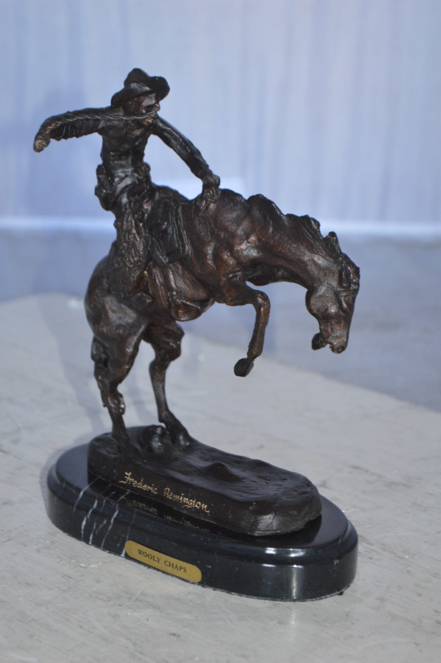 Wooly Chaps Bronze Statue by Remington 13H -  Size: 8"L x 3"W x 9"H.