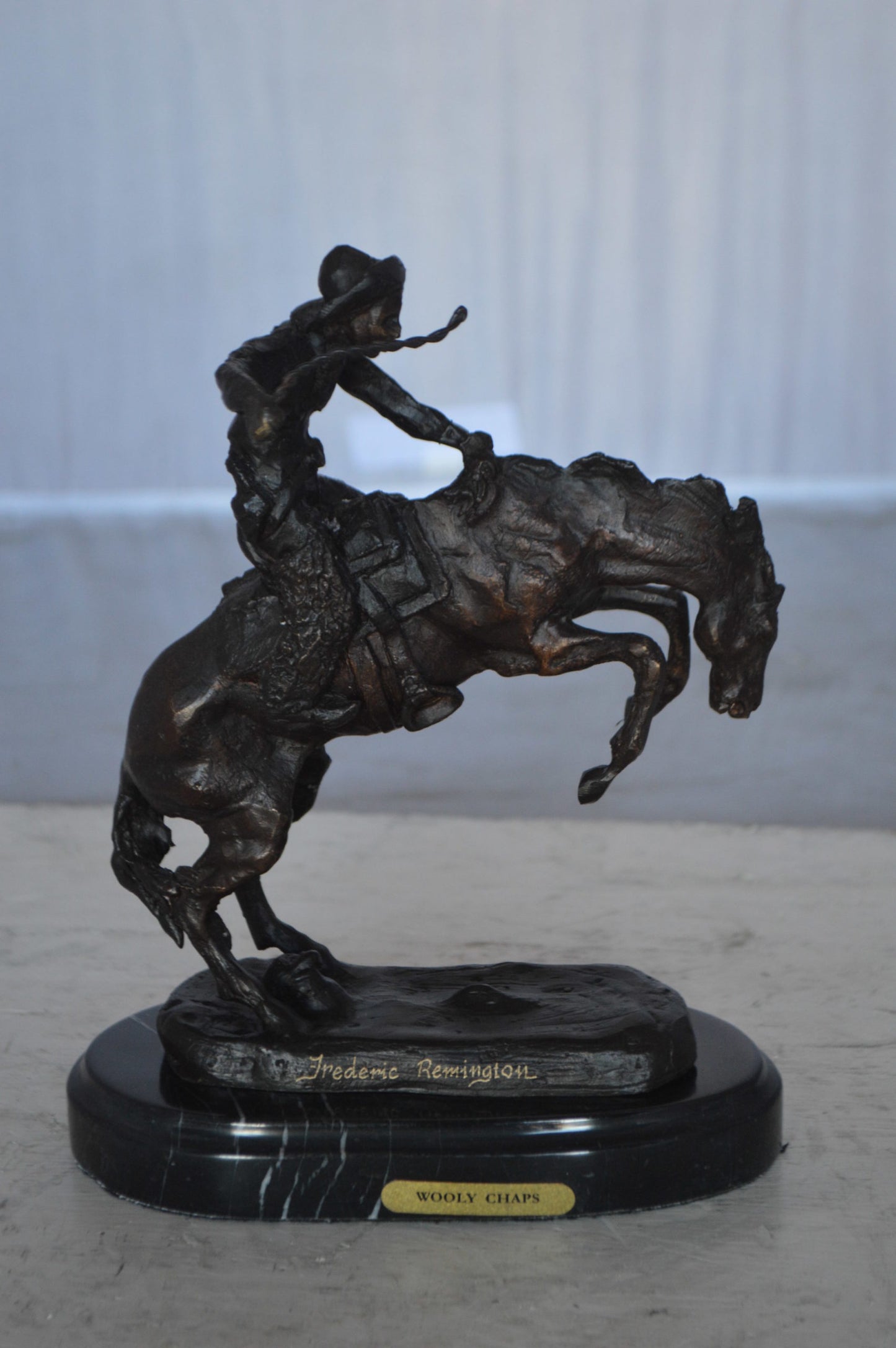 Wooly Chaps Bronze Statue by Remington 13H -  Size: 8"L x 3"W x 9"H.