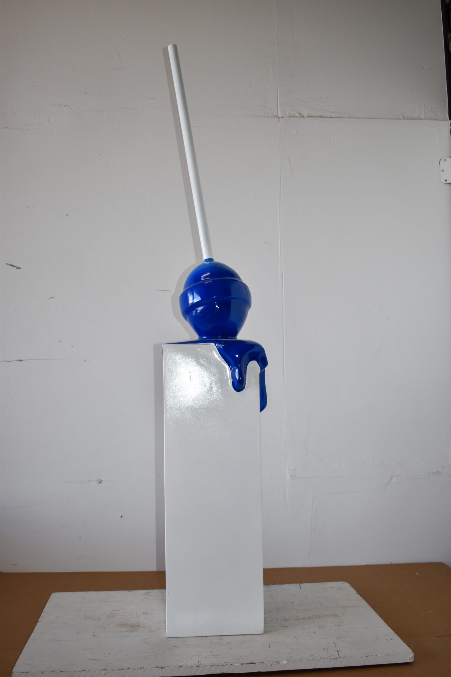 Blue Lollipop Mounted on A White Pedestal Resin Statue Size: 10" x 10" x 59"H