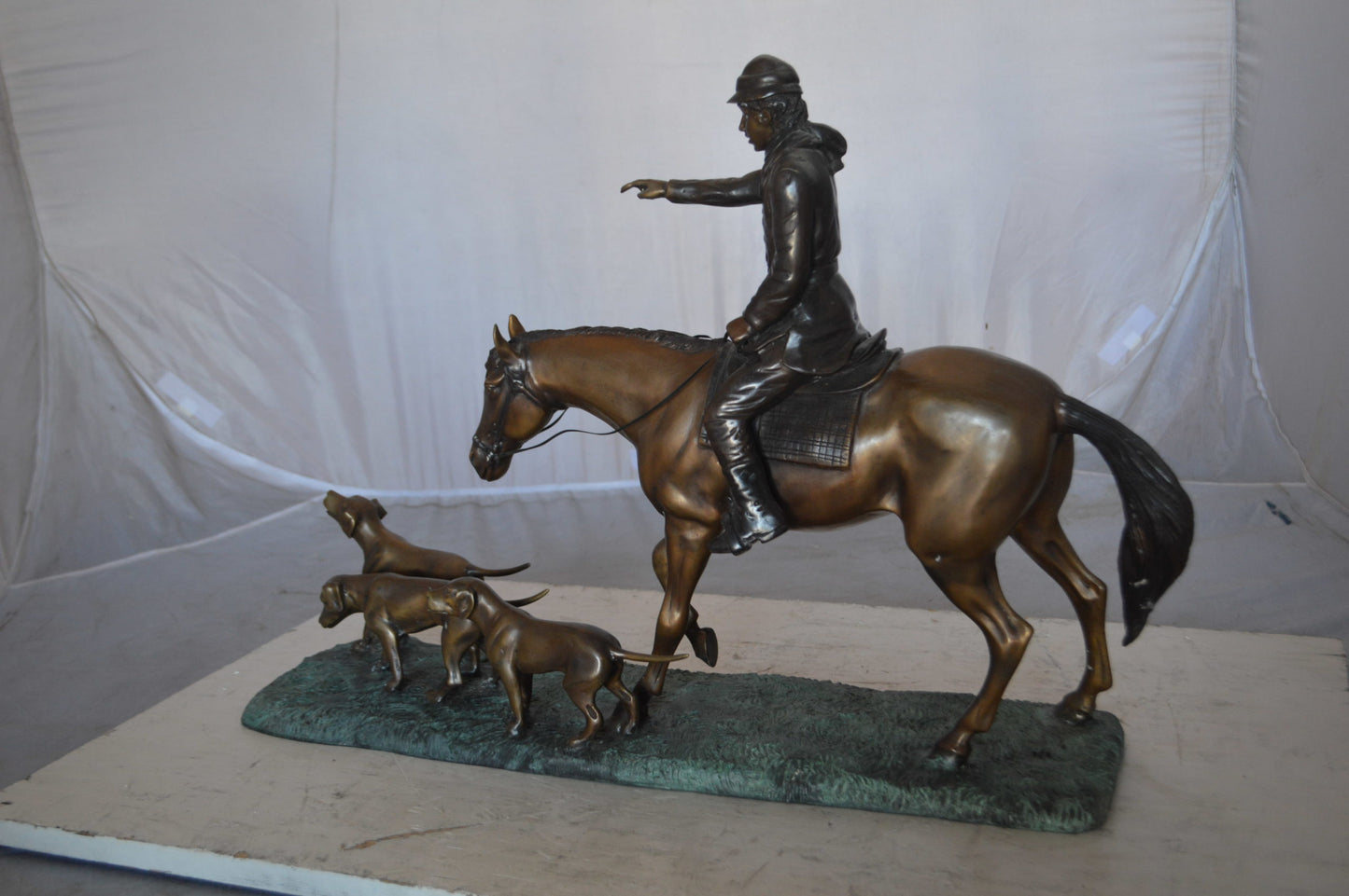Hunter with three dogs Bronze Statue - Size: 27"L x 6"W x 18"H.
