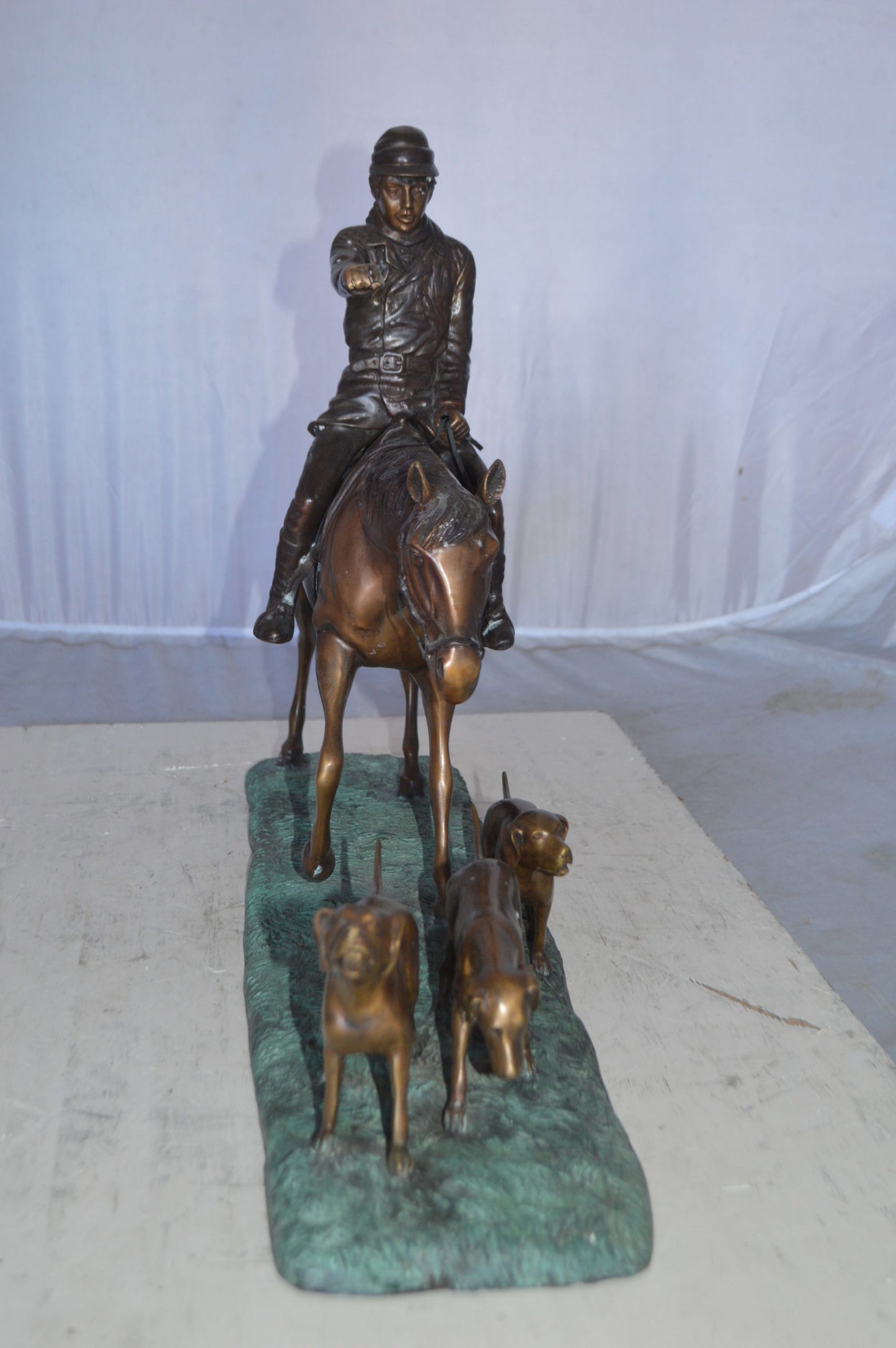 Hunter with three dogs Bronze Statue - Size: 27"L x 6"W x 18"H.