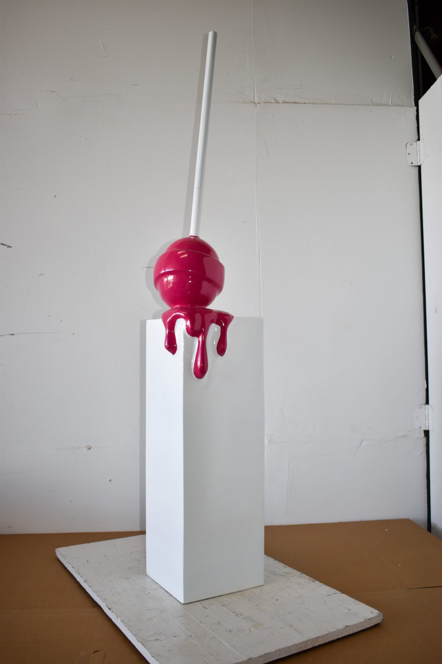Red Lollipop Mounted on A White Pedestal Resin Statue Size: 10" x 10" x 59"H