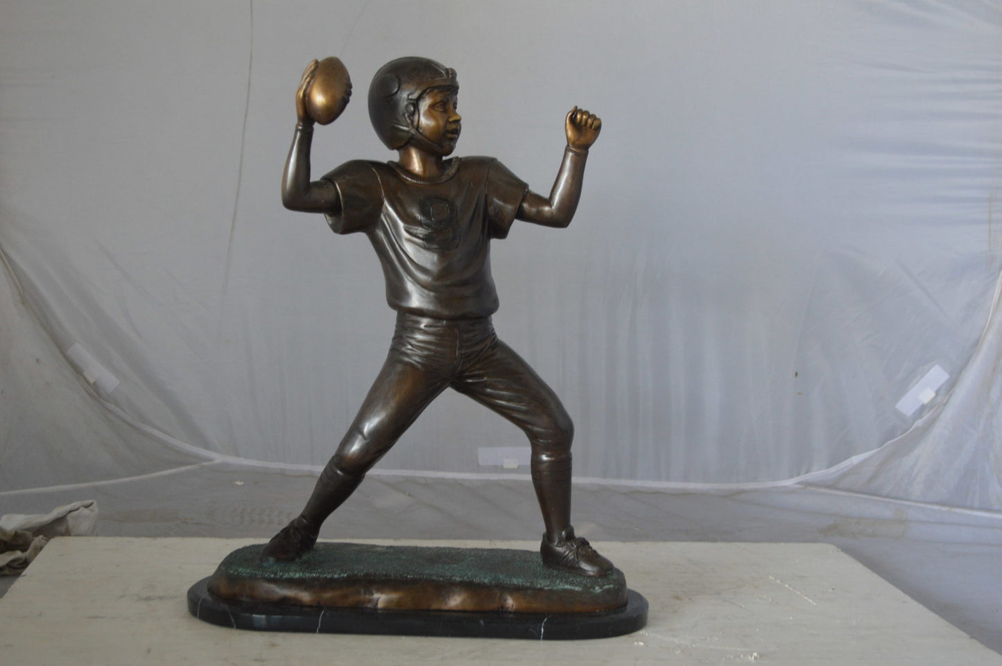 Young Quarterback bronze statue - Size: 14"L x 6"W x 20"H.