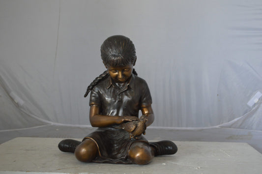 Young seated girl with bird bronze statue - Size: 12"L x 9"W x 14"H.
