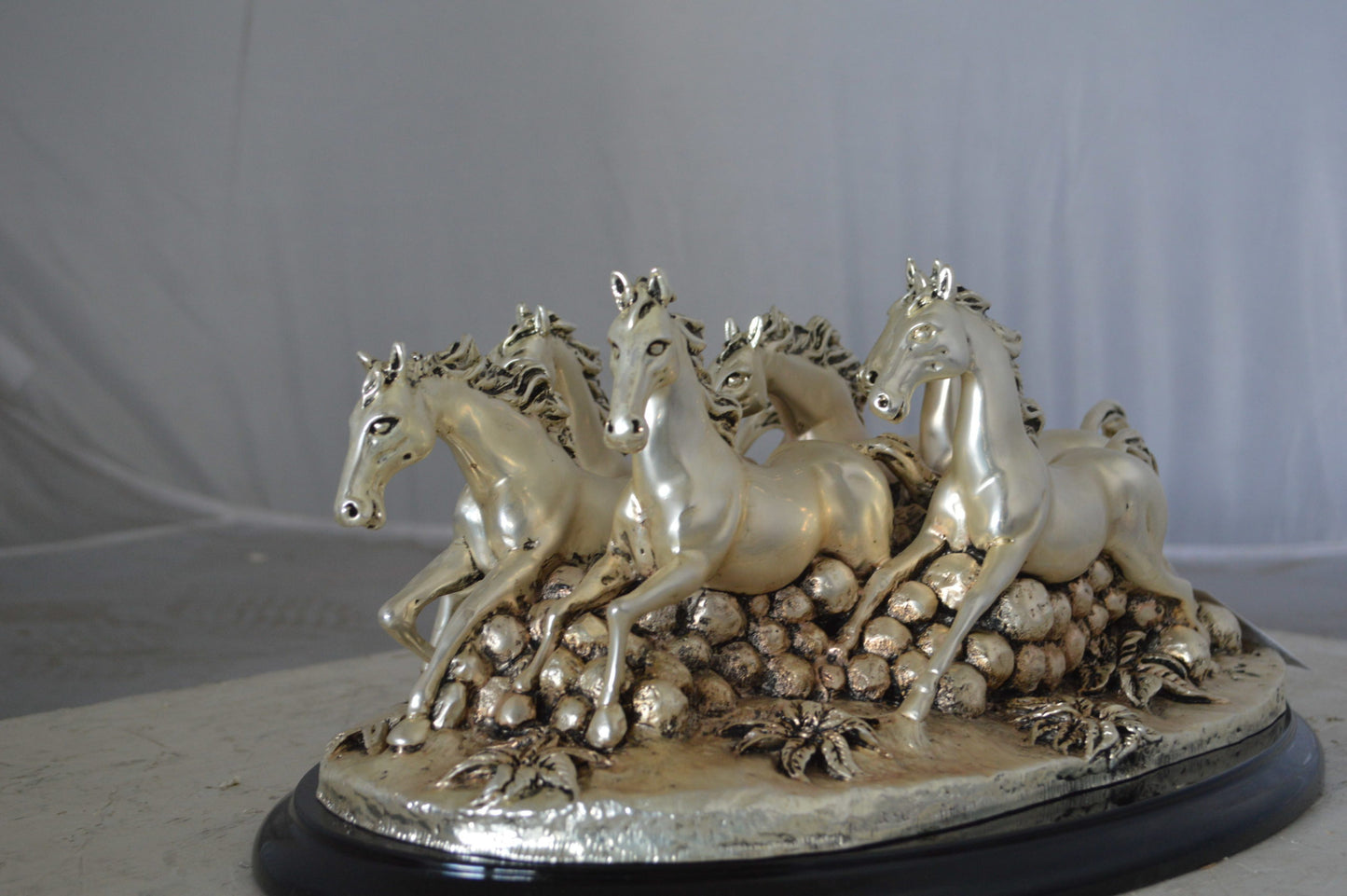 Charging horses resin statue on wood base - Size: 17"L x 10"W x 5"H.