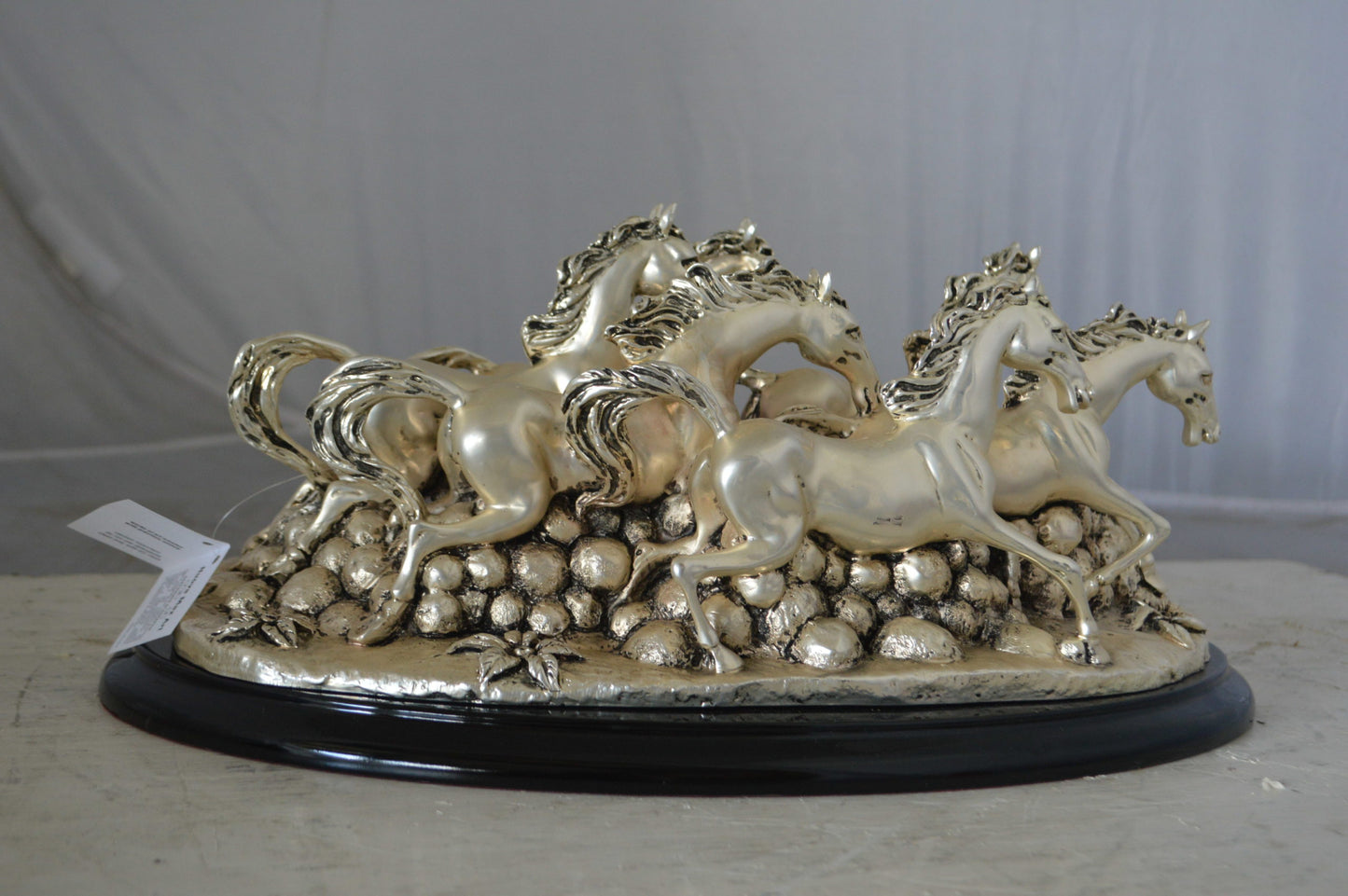 Charging horses resin statue on wood base - Size: 17"L x 10"W x 5"H.