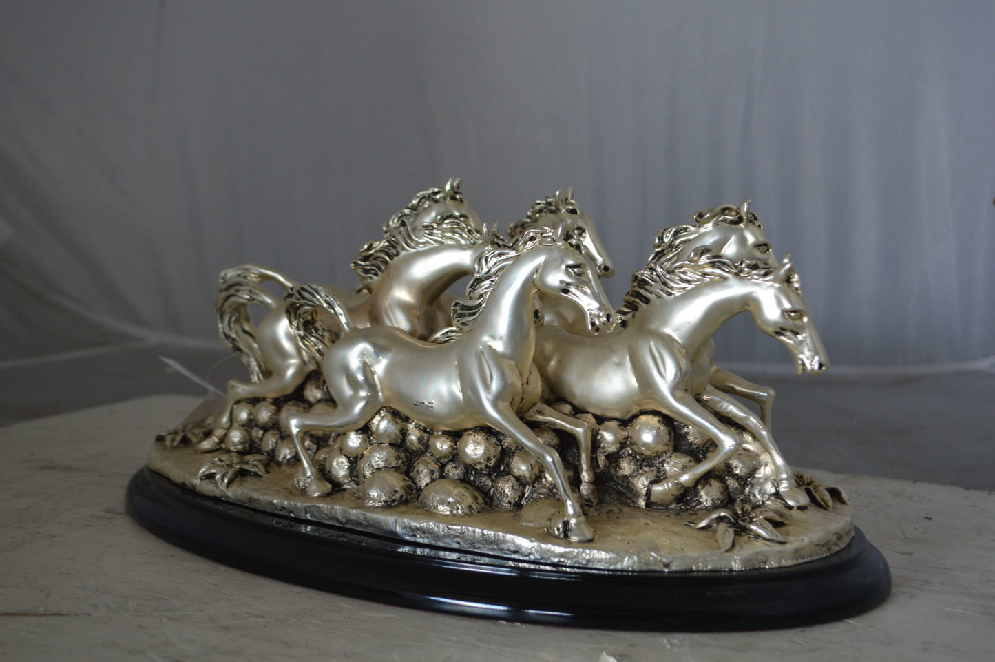 Charging horses resin statue on wood base - Size: 17"L x 10"W x 5"H.