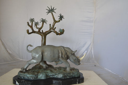 Rhino Relaxed under a tree bronze statue - Size: 22"L x 15"W x 25"H.