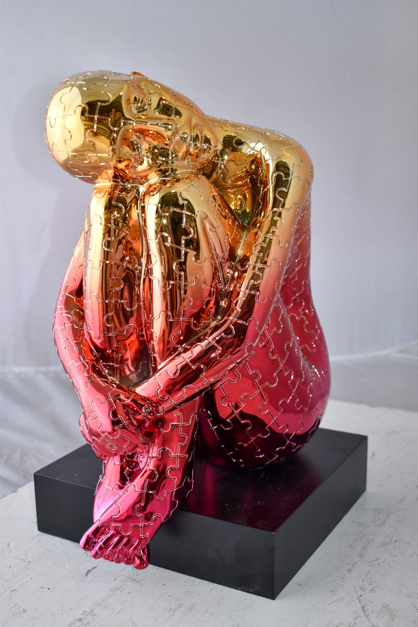 Puzzle Patterned Cradled Woman Resin Statue on Black Base Size: 13" x 12" x 19"H