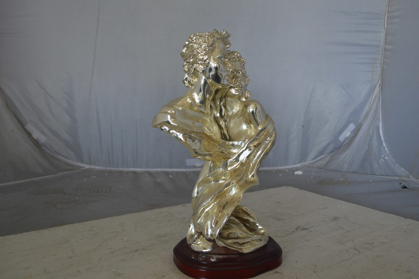 Lovers resin statue on wood base - Size: 8"L x 5"W x 14"H.