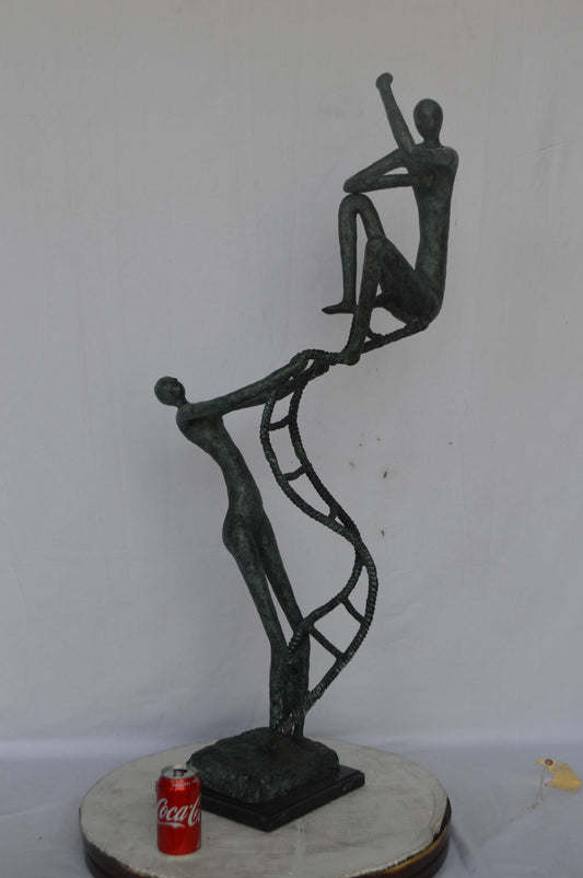 Modern art, two men climbing a latter bronze statue - Size: 14"L x 15"W x 47"H.