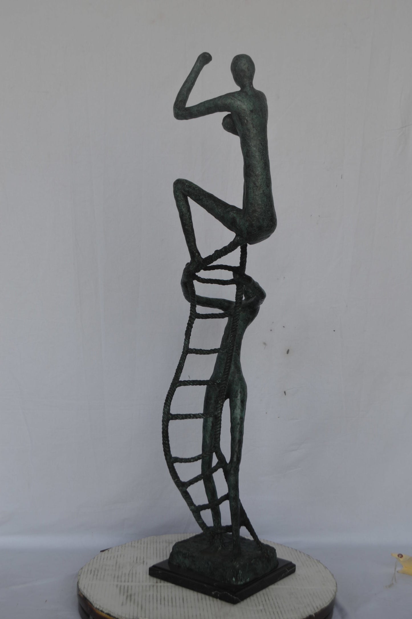 Modern art, two men climbing a latter bronze statue - Size: 14"L x 15"W x 47"H.