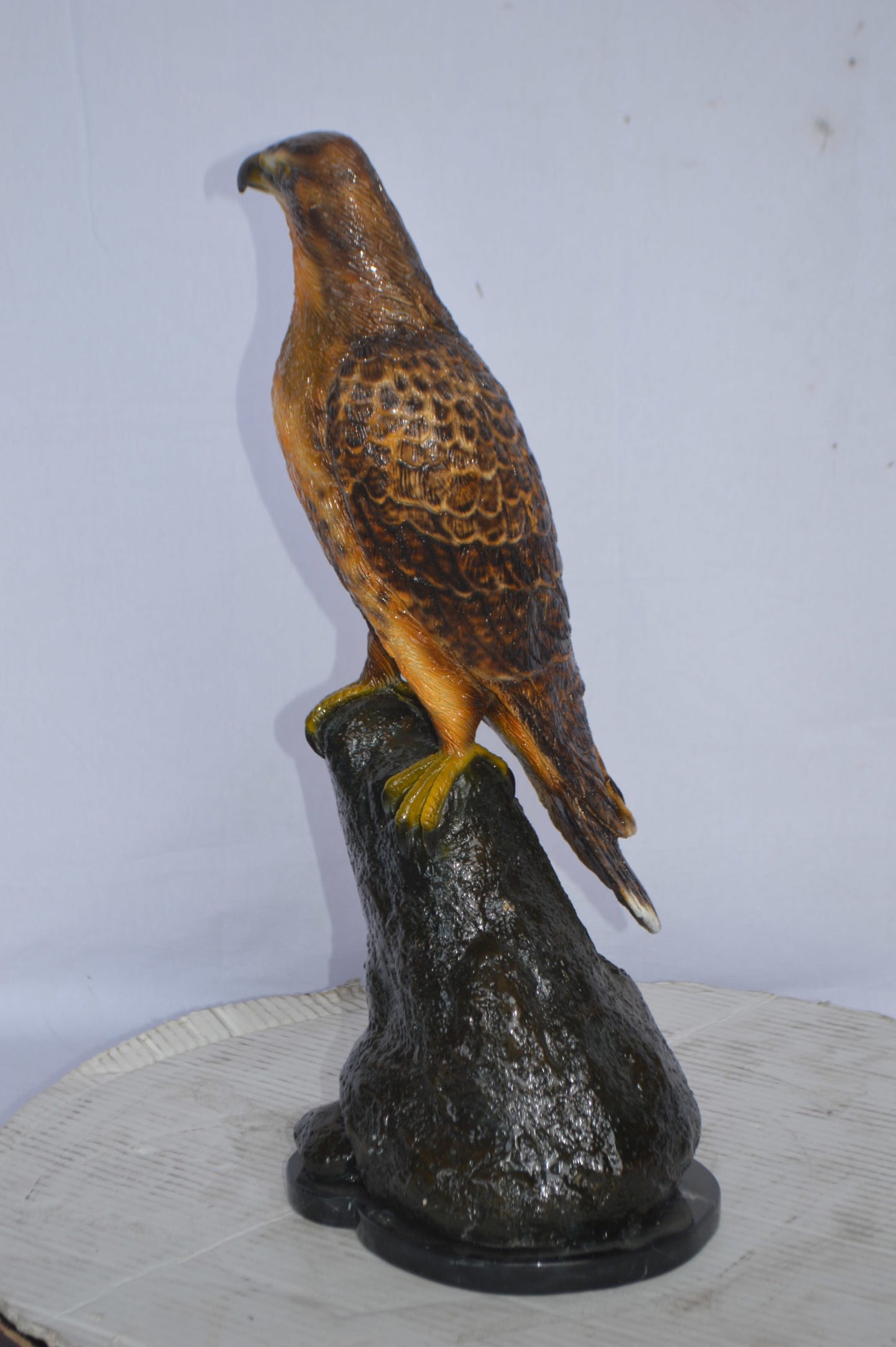 Hawk on a Rock bronze statue - Size: 12"L x 9"W x 22"H.