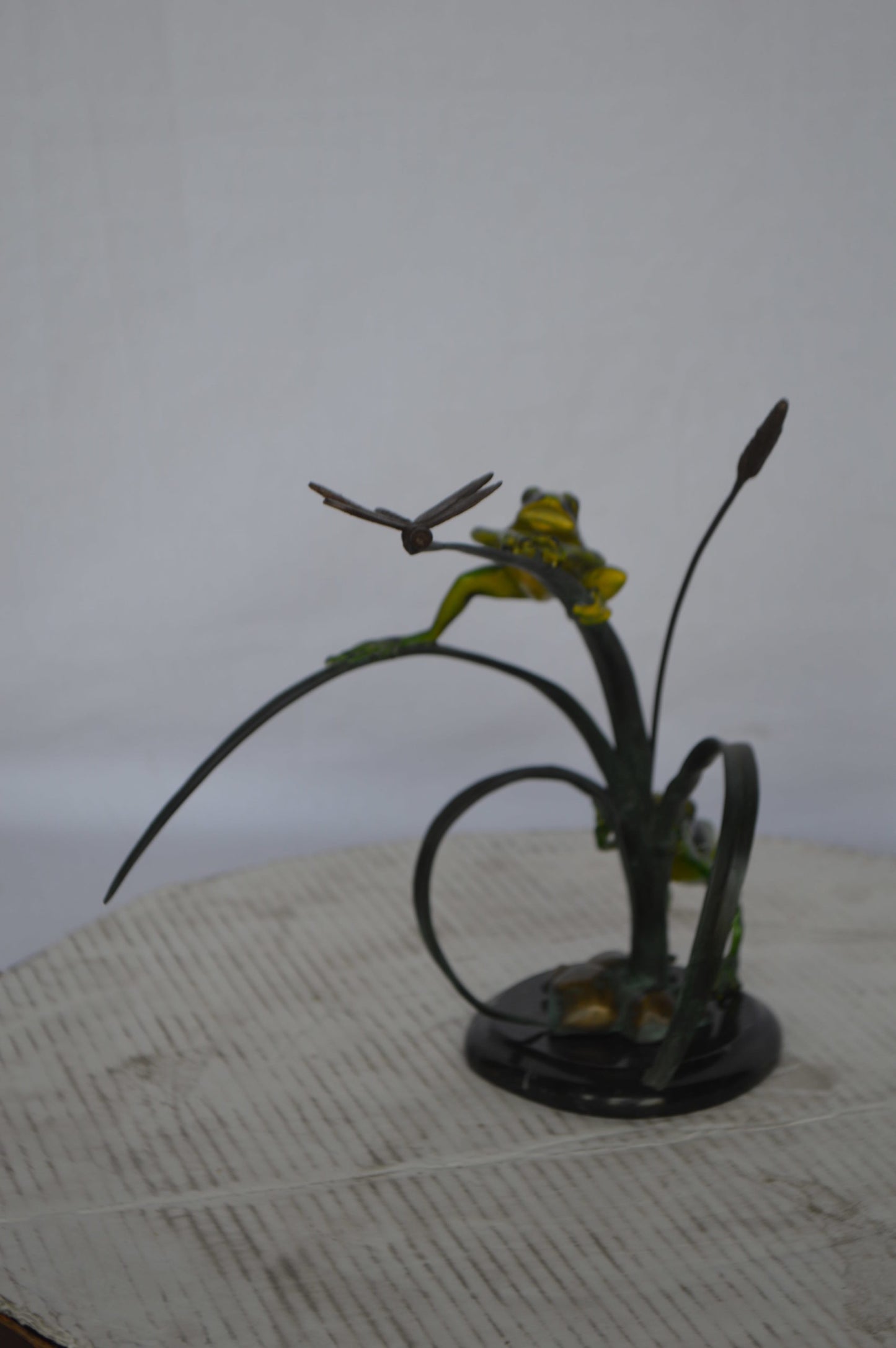 Two Green Frogs catching a dragonfly Bronze Statue - Size: 17"L x 10"W x 13"H.