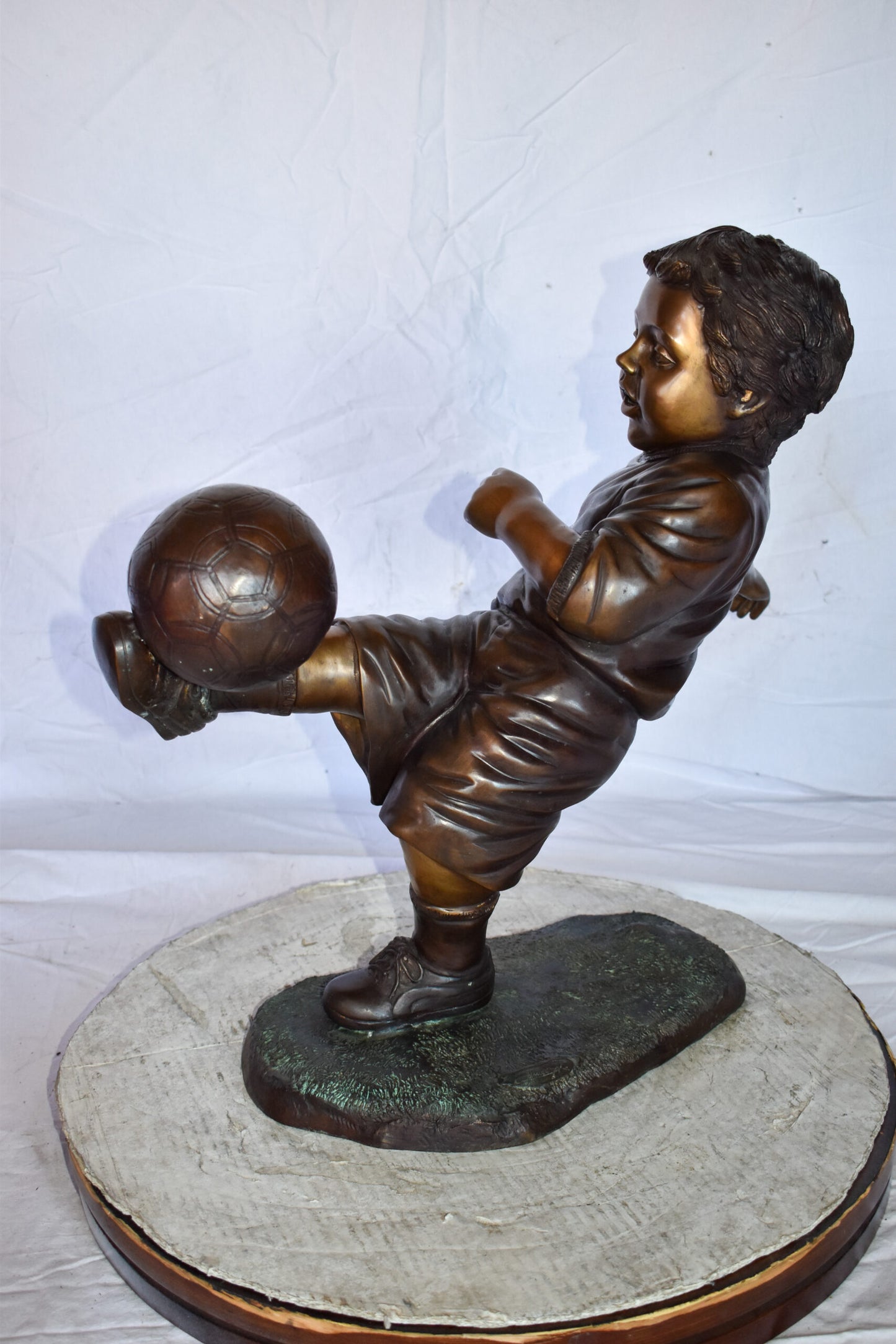 Young Boy Passionately Kicking Soccer Ball Bronze Statue  Size: 26" x 16" x 24"H