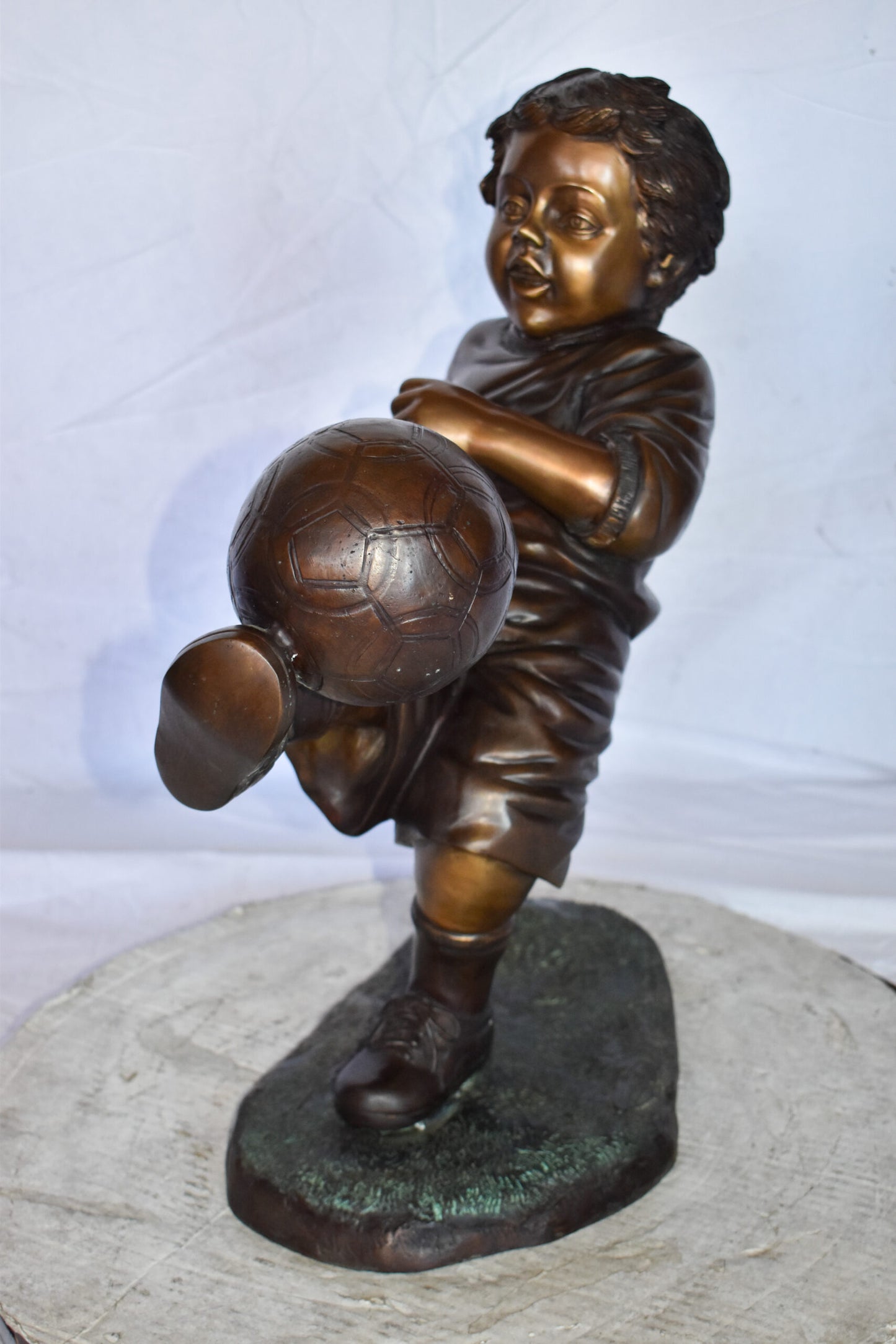 Young Boy Passionately Kicking Soccer Ball Bronze Statue  Size: 26" x 16" x 24"H