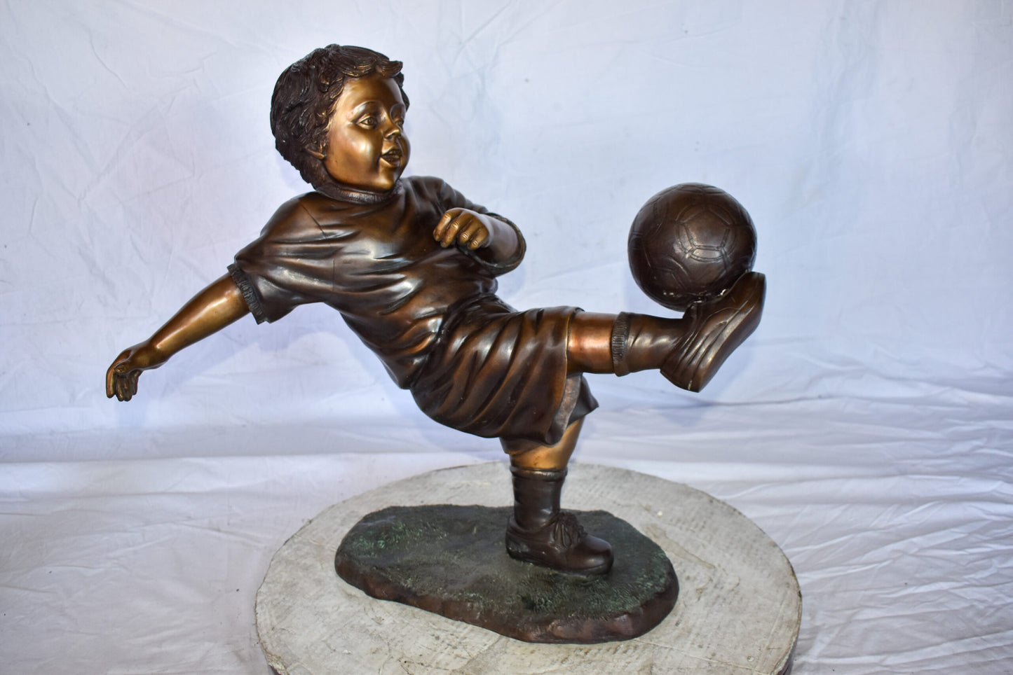 Young Boy Passionately Kicking Soccer Ball Bronze Statue  Size: 26" x 16" x 24"H