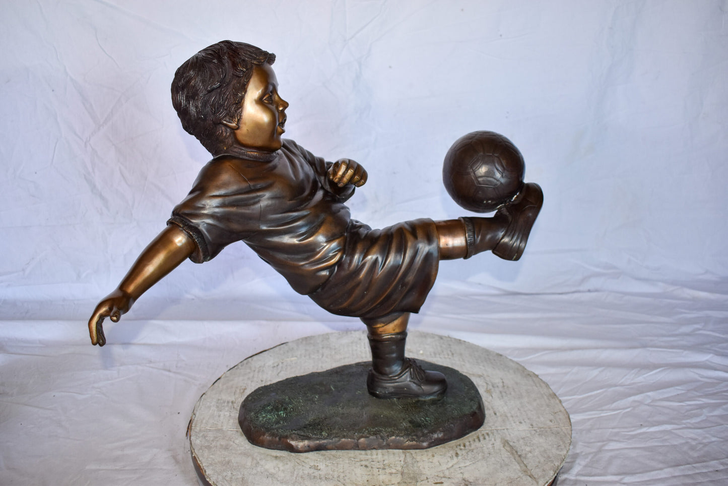 Young Boy Passionately Kicking Soccer Ball Bronze Statue  Size: 26" x 16" x 24"H
