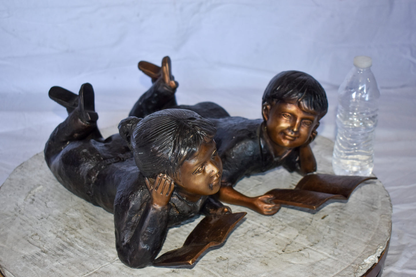 Young Kids Laying and Reading Cheerfully Bronze Statue Set Size: 20" x 13" x 8"H