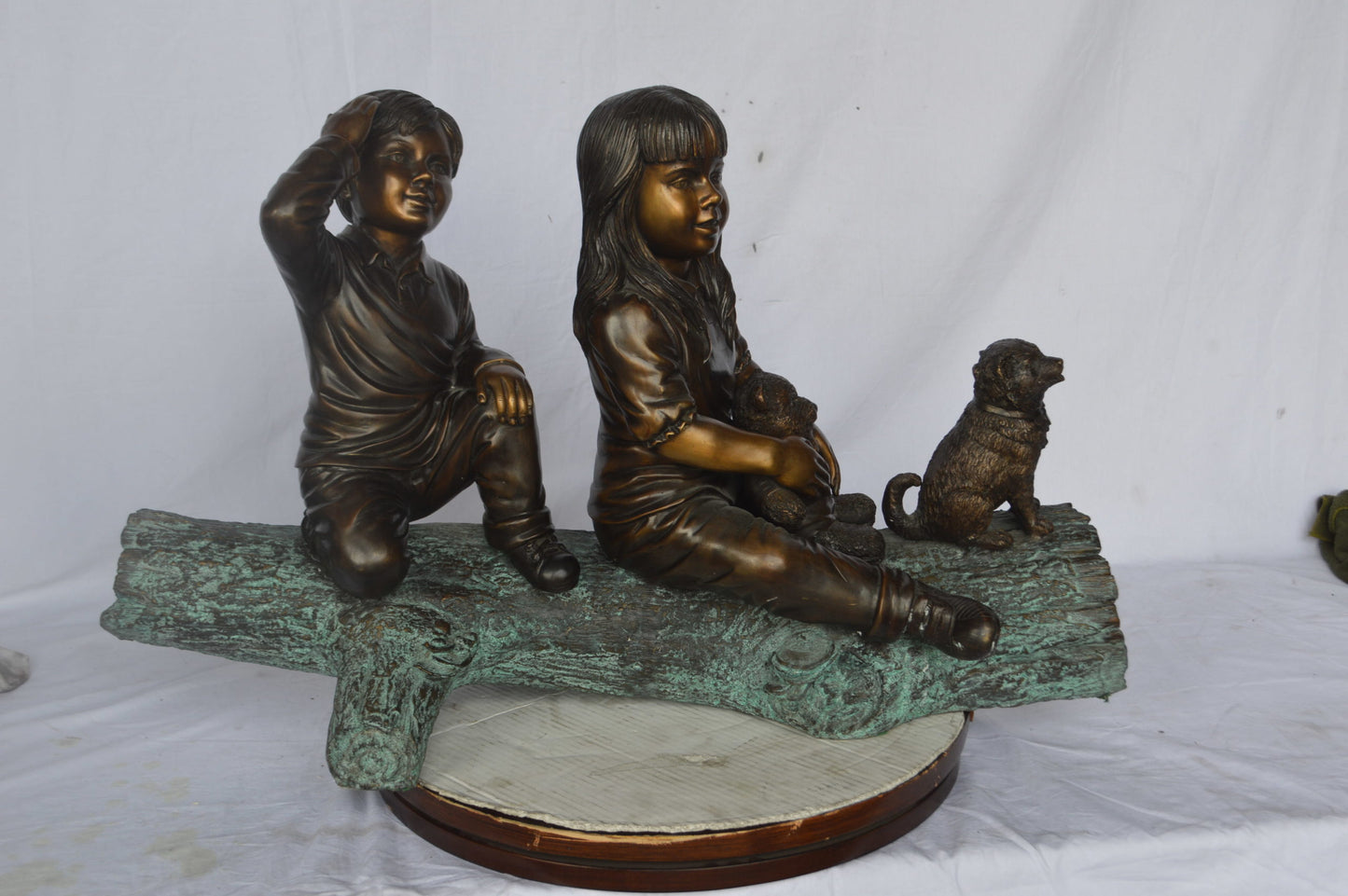 Young children and dog on a log bronze statue - Size: 40"L x 16"W x 24"H.