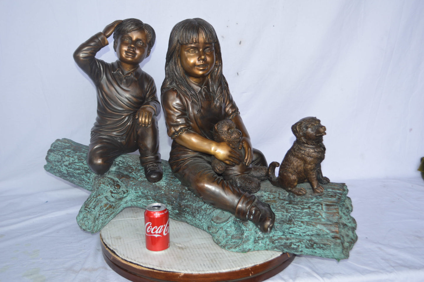 Young children and dog on a log bronze statue - Size: 40"L x 16"W x 24"H.