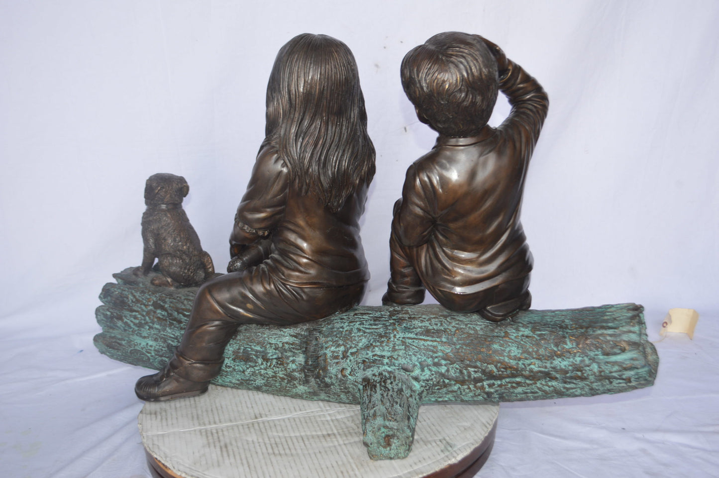 Young children and dog on a log bronze statue - Size: 40"L x 16"W x 24"H.