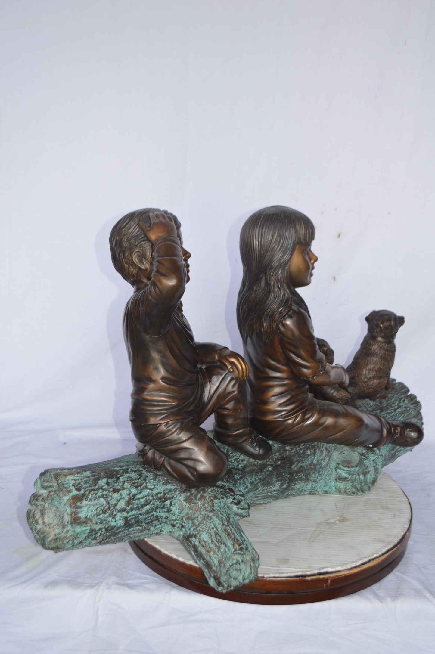 Young children and dog on a log bronze statue - Size: 40"L x 16"W x 24"H.