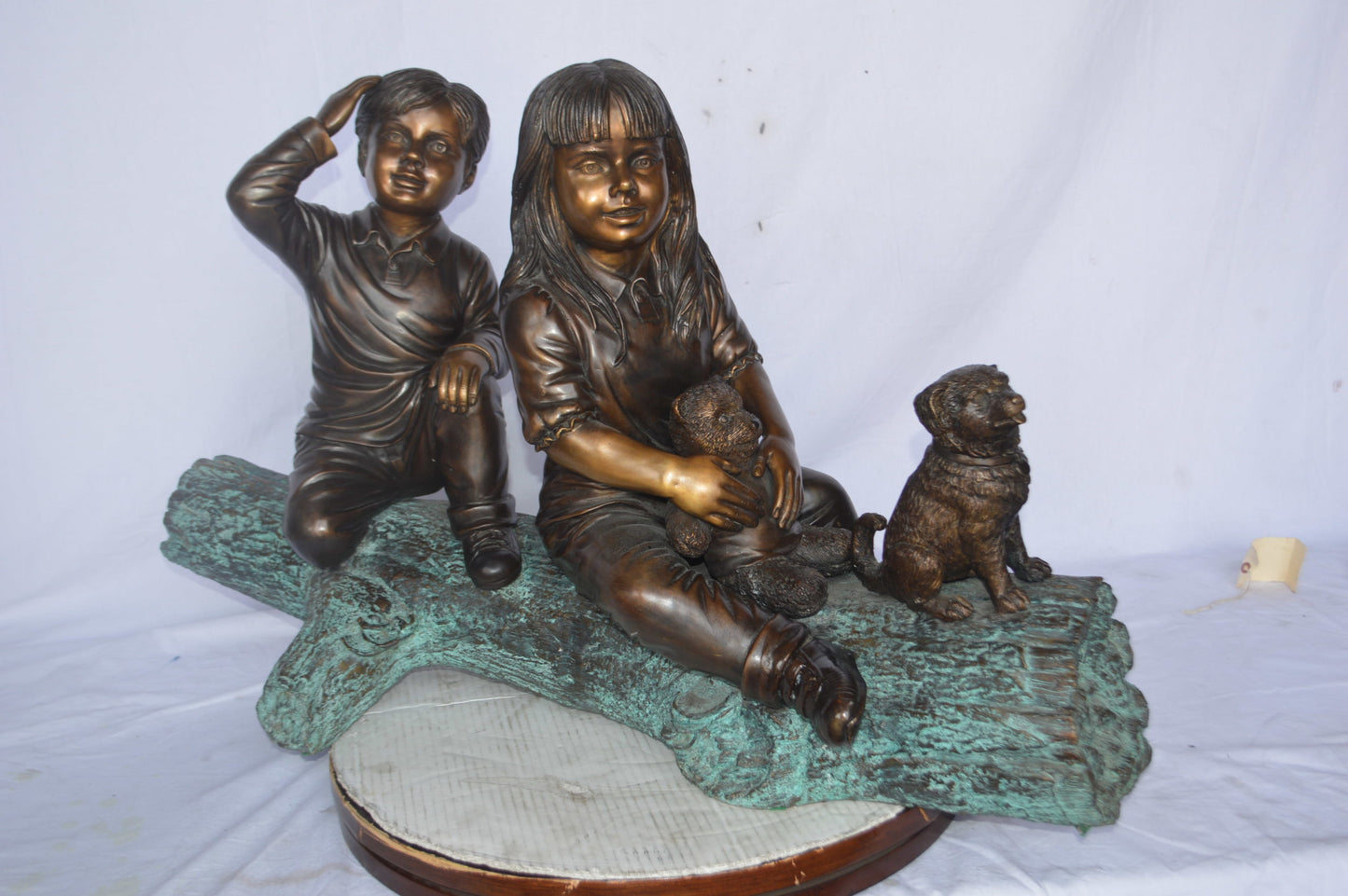 Young children and dog on a log bronze statue - Size: 40"L x 16"W x 24"H.
