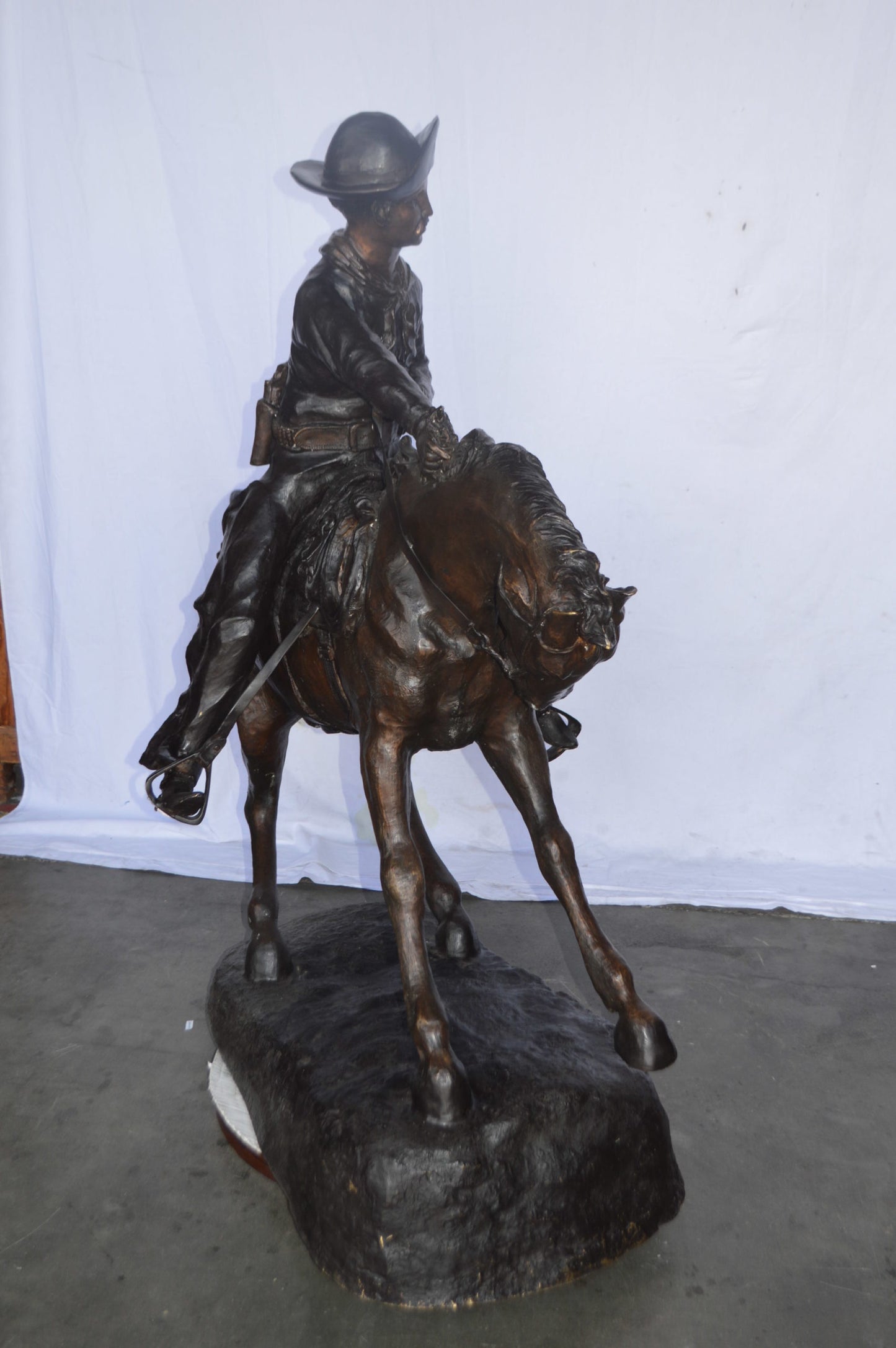 Giant Cowboy Remington bronze statue - Size: 66"L x 30"W x 58"H.
