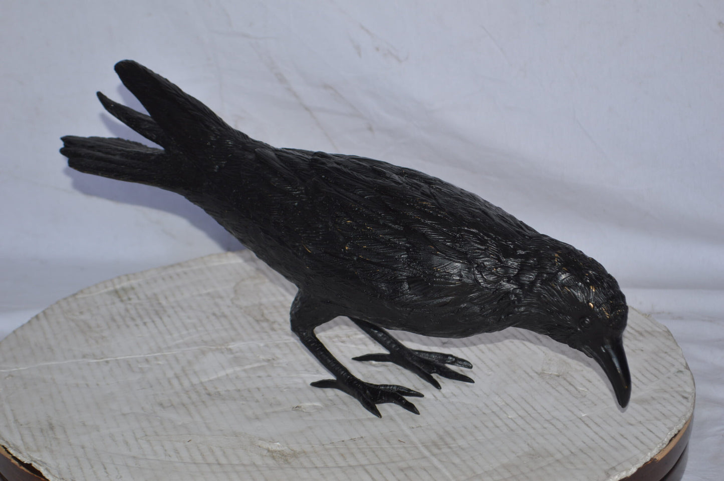 Raven with his head down Bronze Statue - Size: 22"L x 6"W x 11"H.