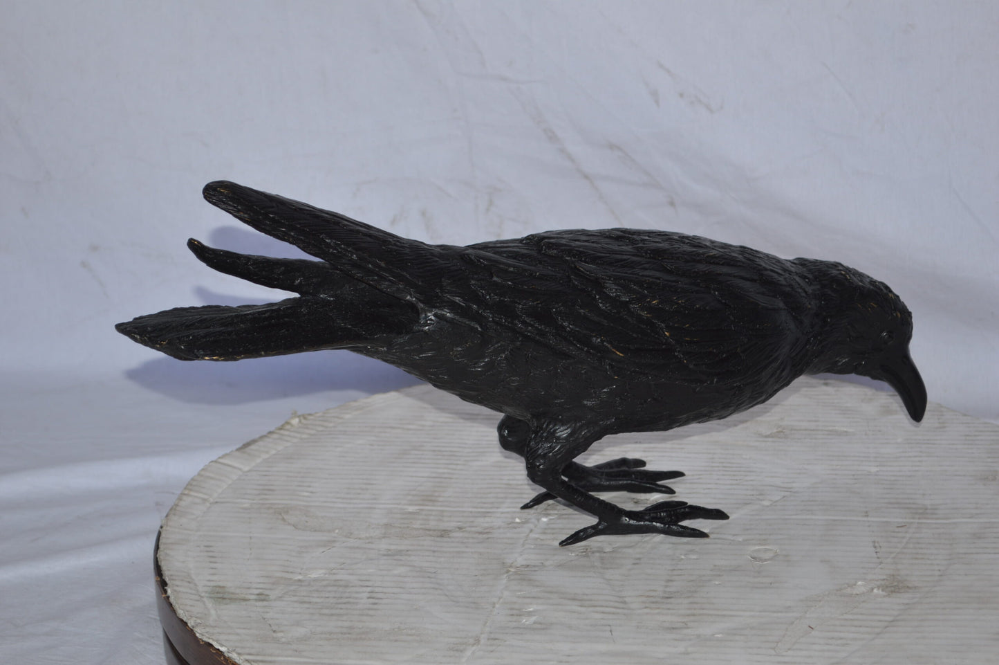 Raven with his head down Bronze Statue - Size: 22"L x 6"W x 11"H.