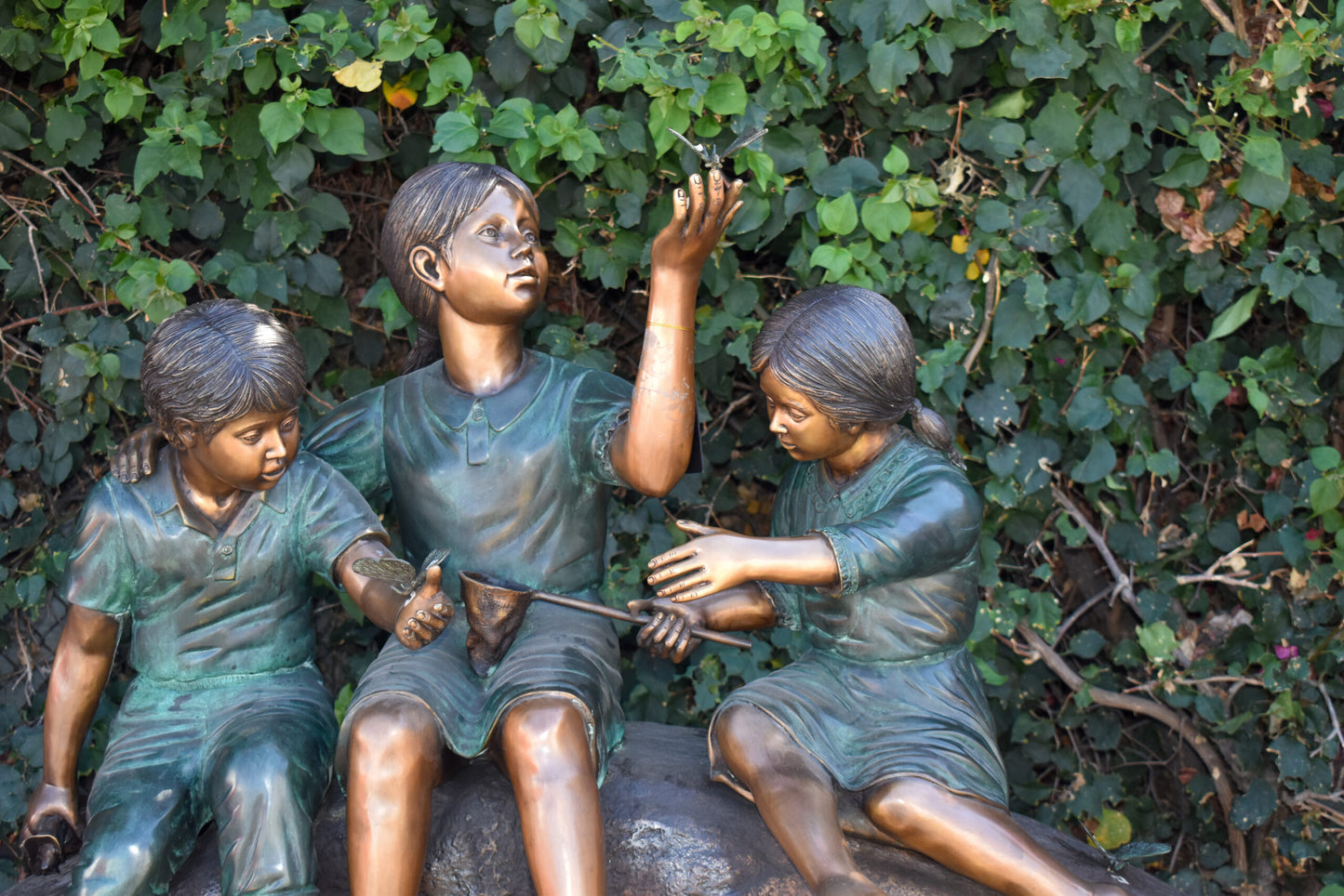 Three Kids Playing With Butterflies Bronze Statue - Size: 70"L x 25"W x 45"H.