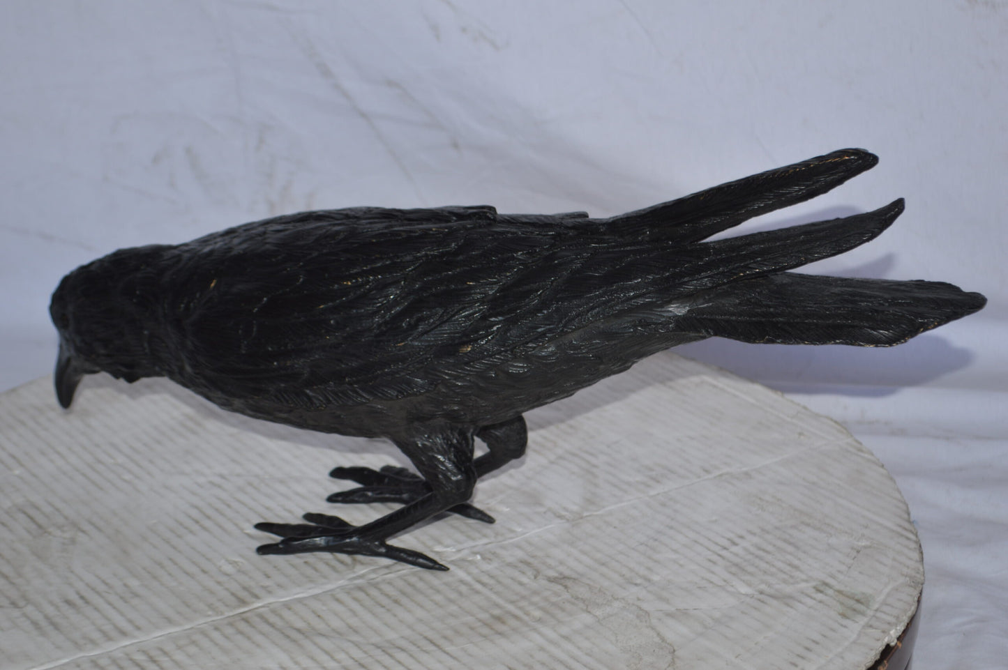 Raven with his head down Bronze Statue - Size: 22"L x 6"W x 11"H.