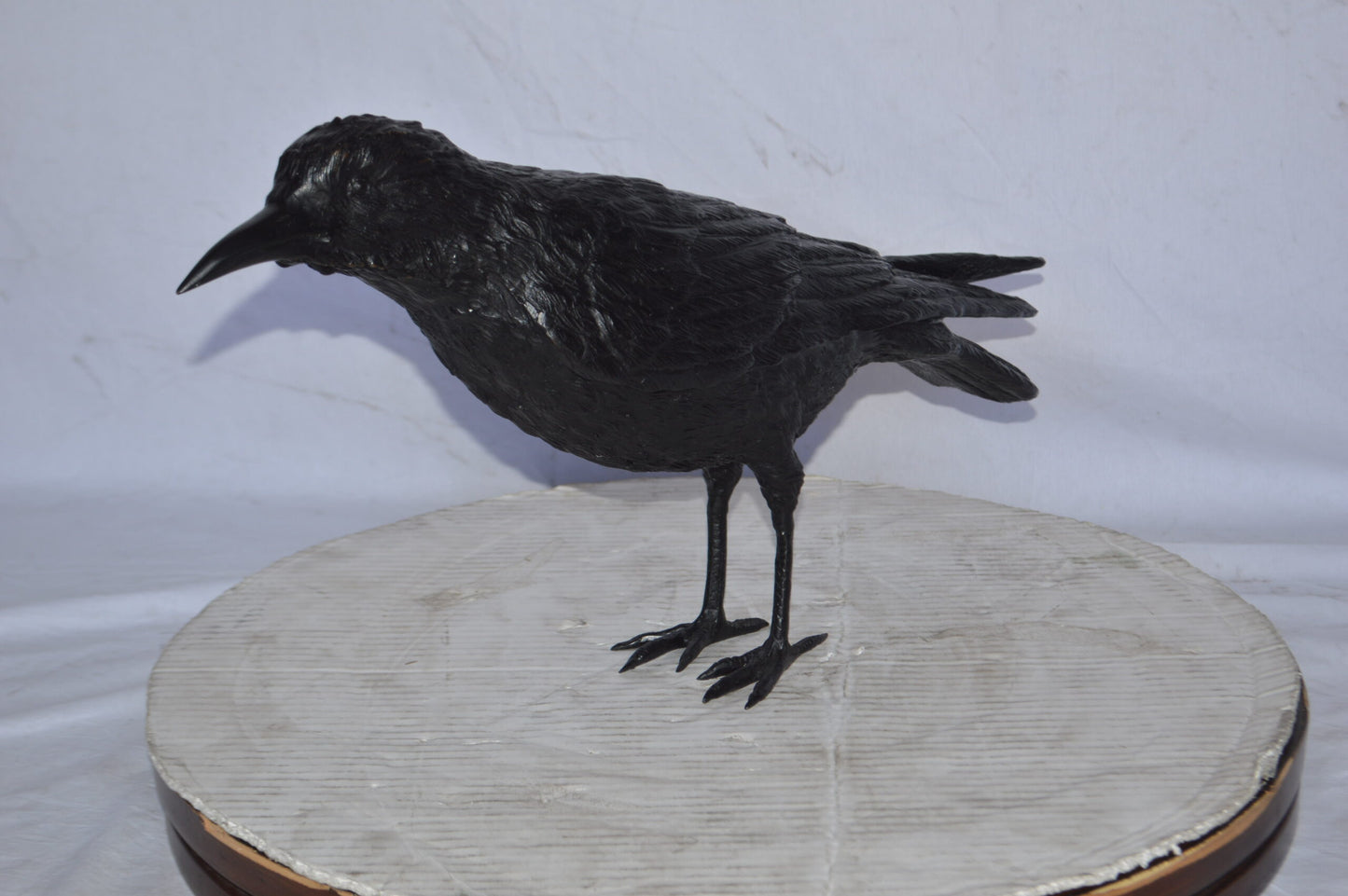 Raven with his head up Bronze Statue - Size: 23"L x 6"W x 13"H.