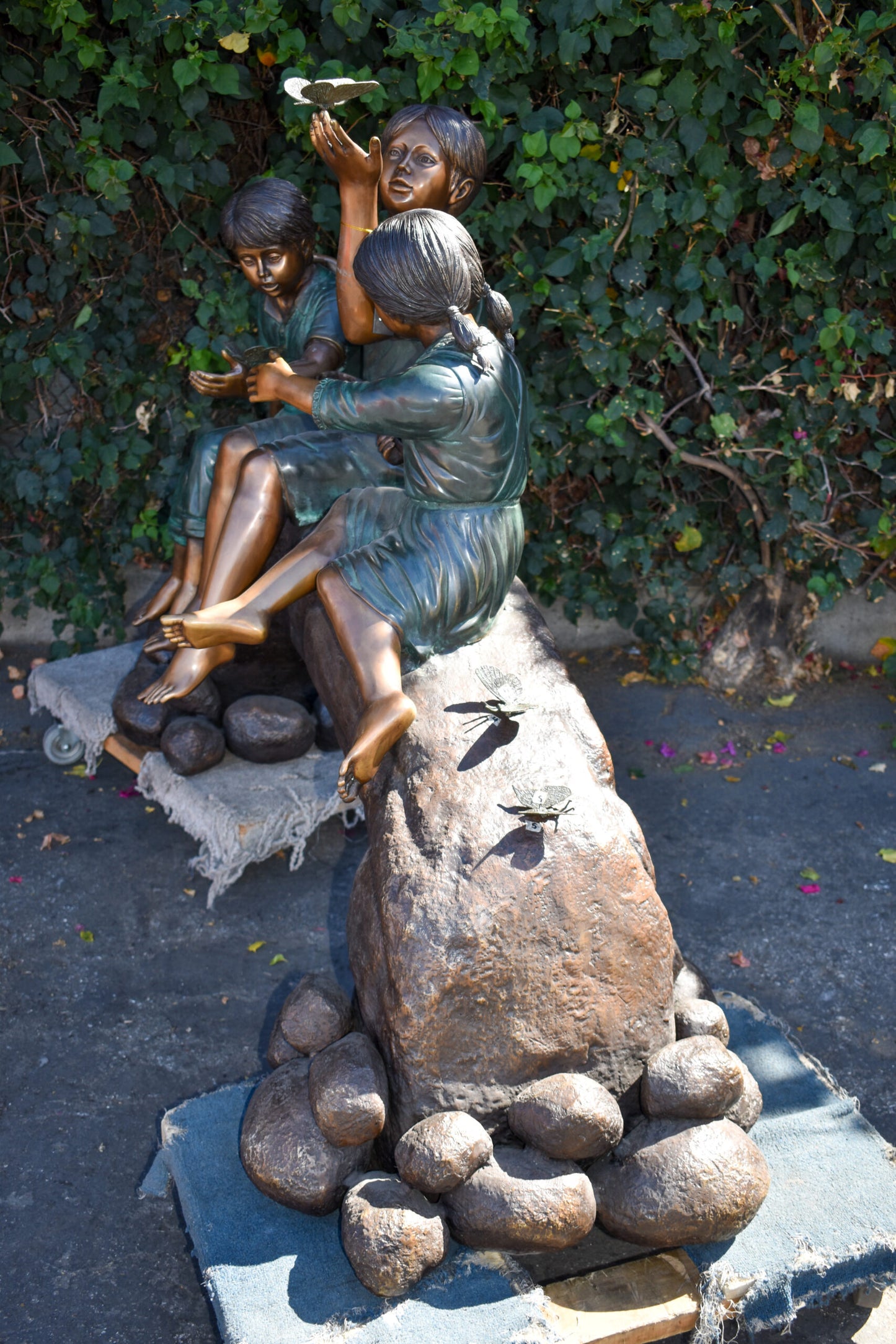 Three Kids Playing With Butterflies Bronze Statue - Size: 70"L x 25"W x 45"H.