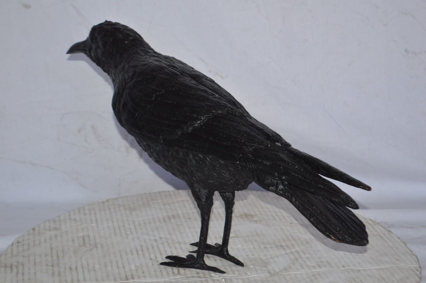 Raven with his head up Bronze Statue - Size: 23"L x 6"W x 13"H.