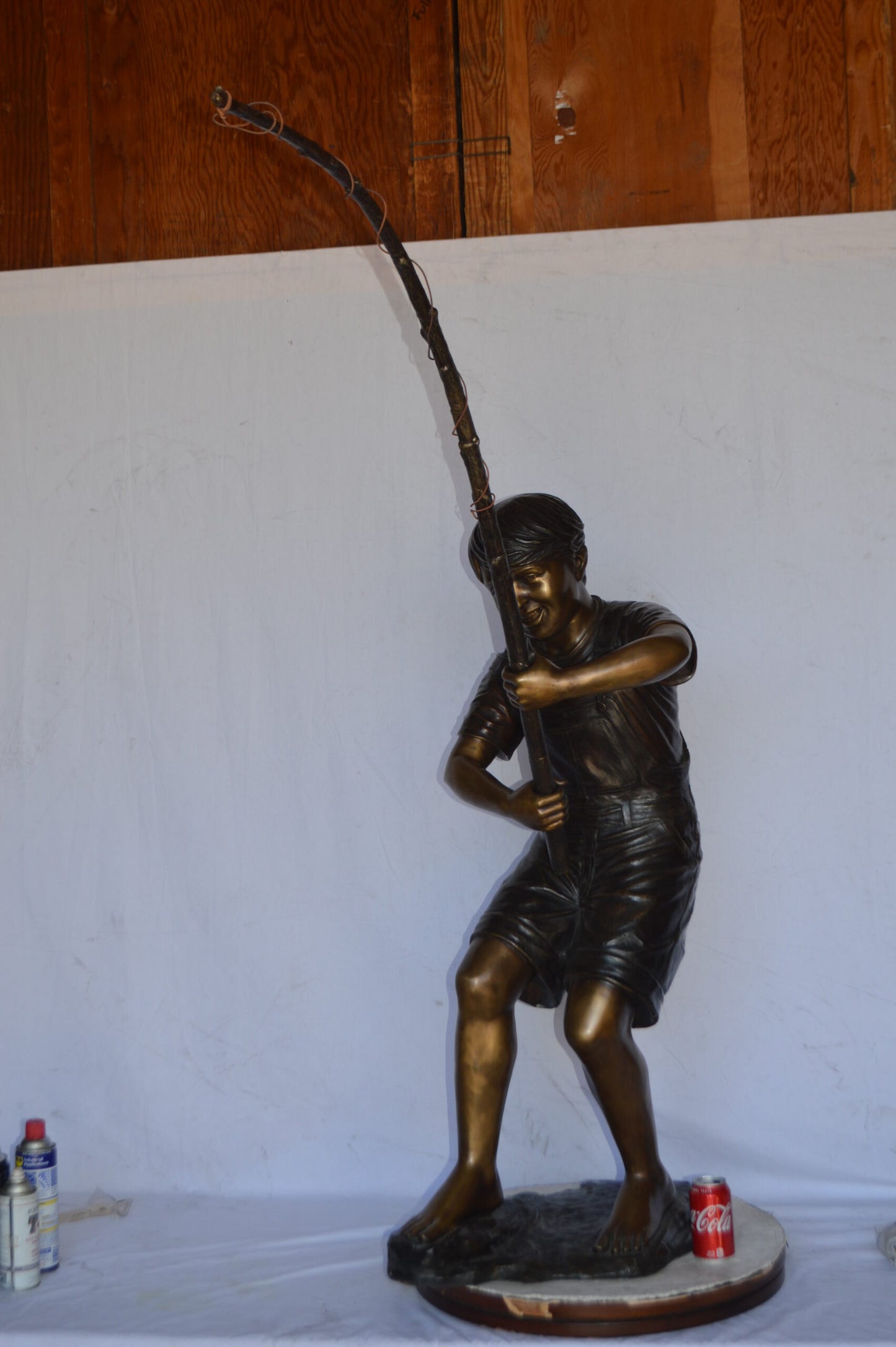 A Young Boy Fishing Bronze Statue - Size: 16"L x 54"W x 62"H.