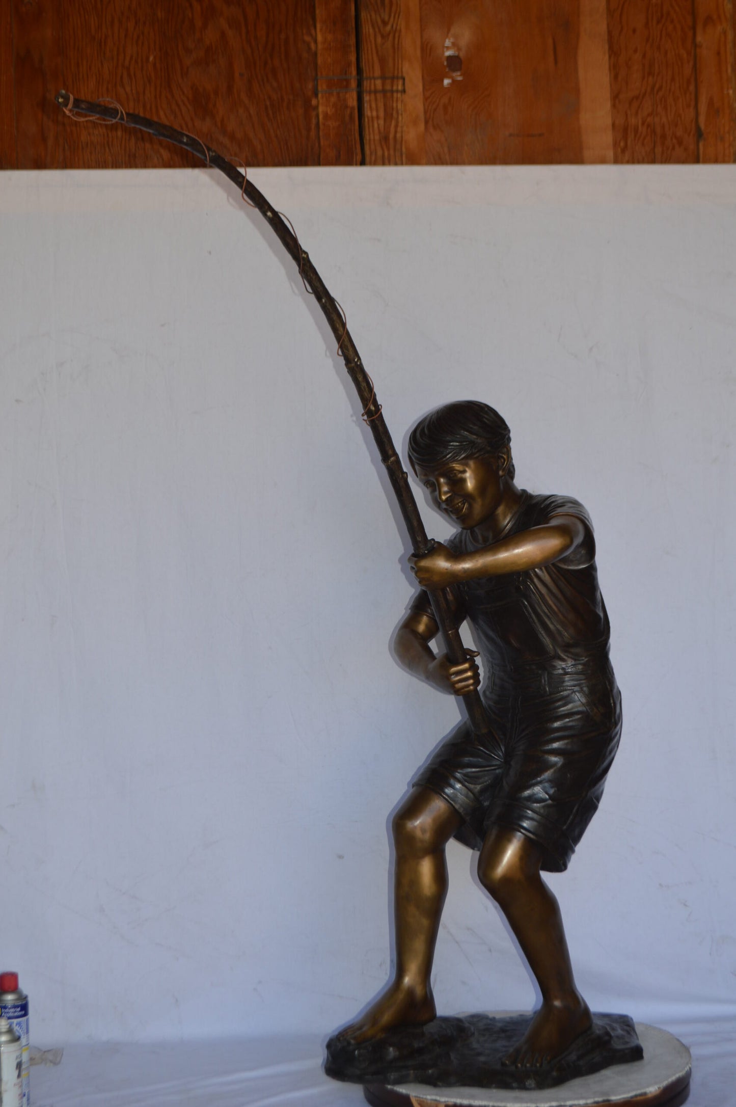 A Young Boy Fishing Bronze Statue - Size: 16"L x 54"W x 62"H.