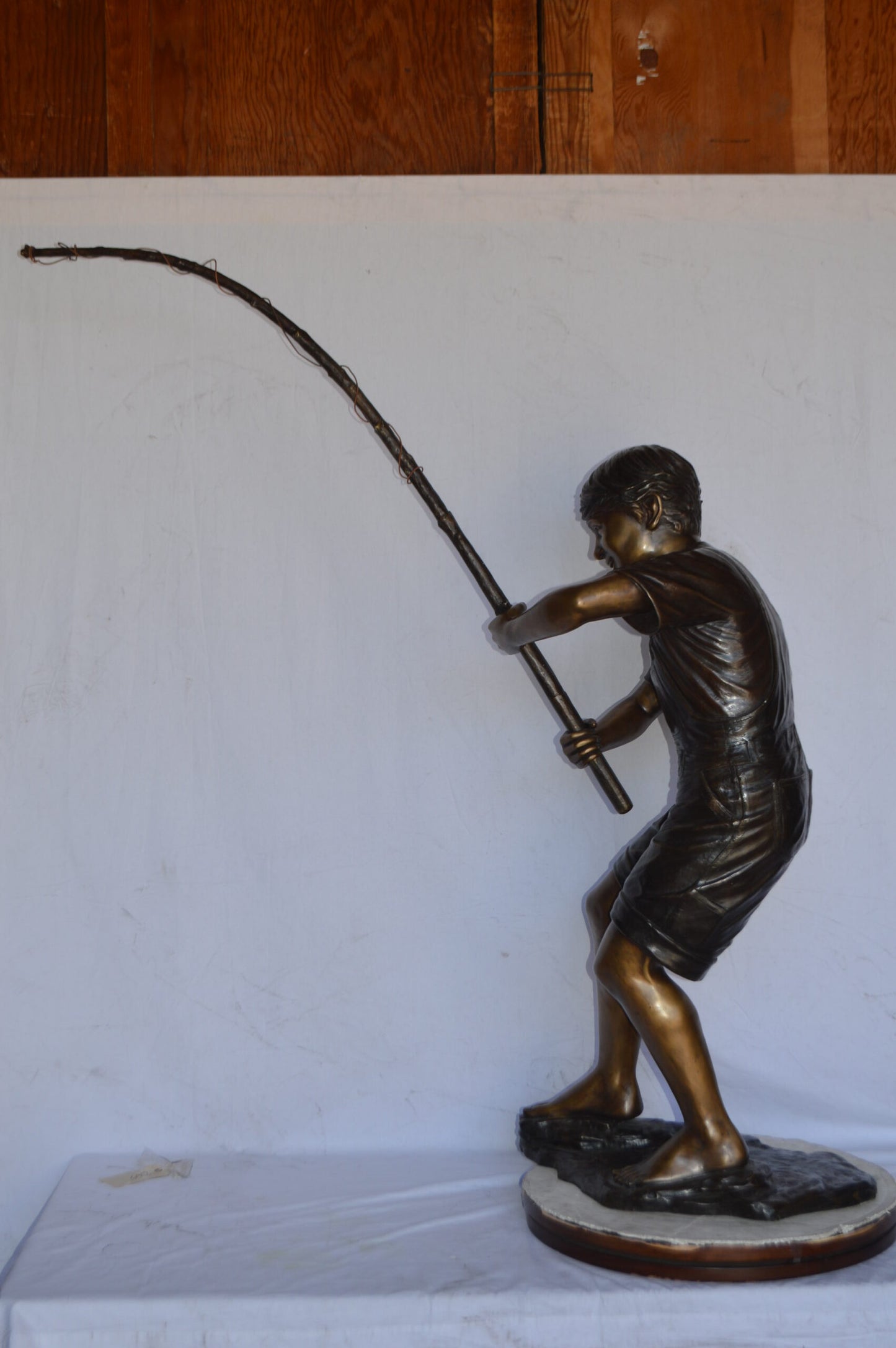 A Young Boy Fishing Bronze Statue - Size: 16"L x 54"W x 62"H.